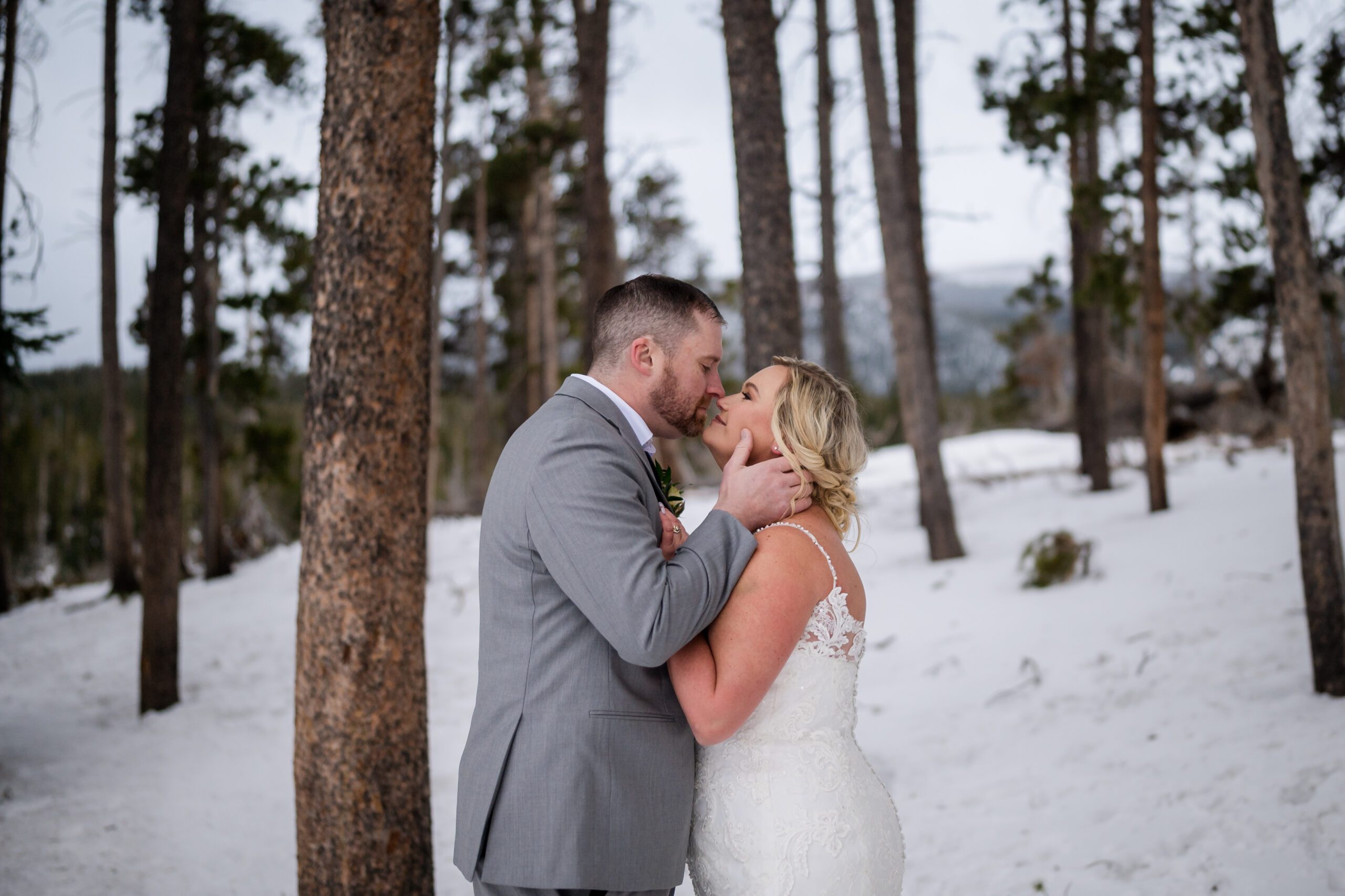 the bride and groom close to kissing in the snowy winter landscape - during their Winter Elopement at Sprague Lake. 