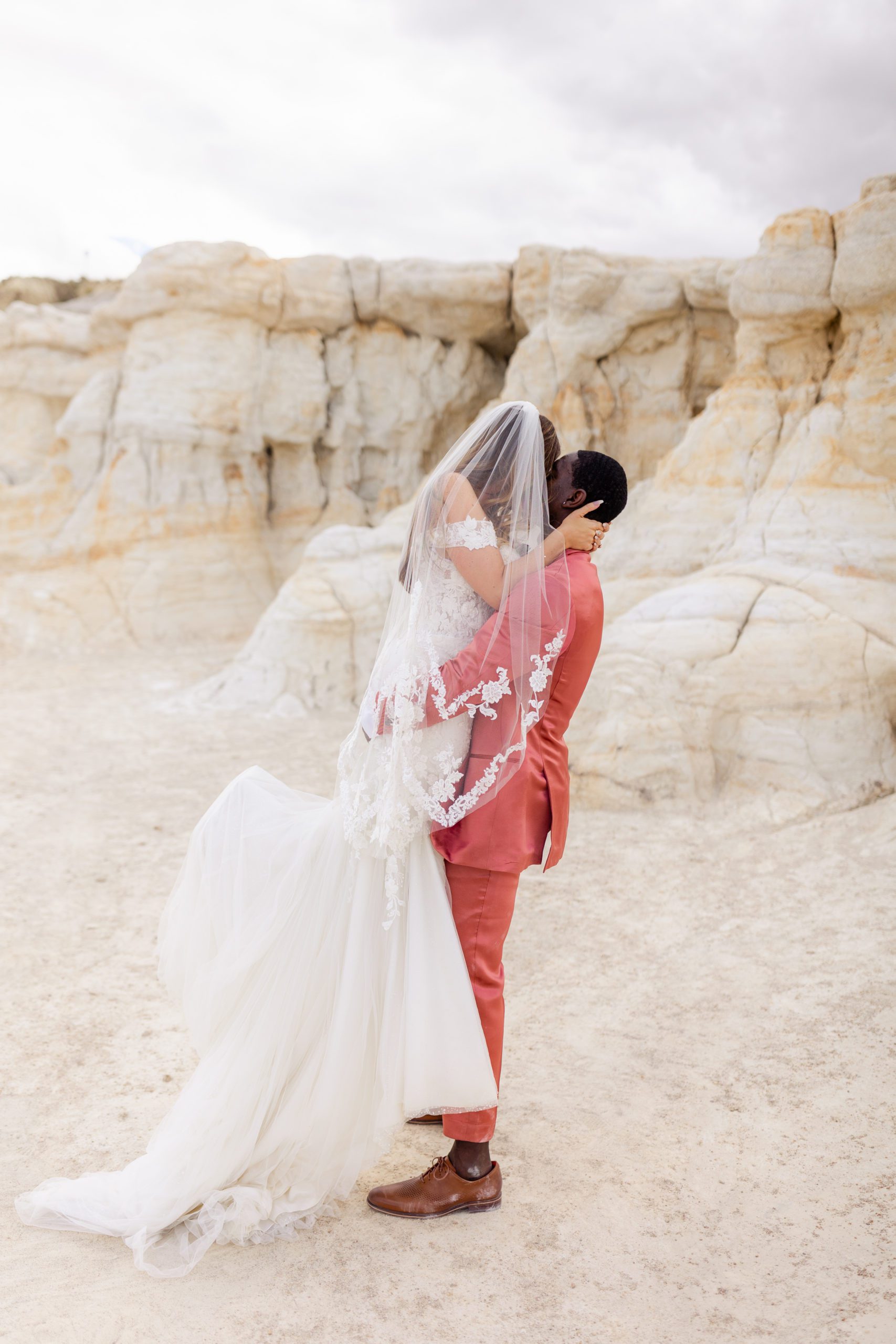 Bride kissing groom at the Paint Mines before their elopement at the Garden of the Gods