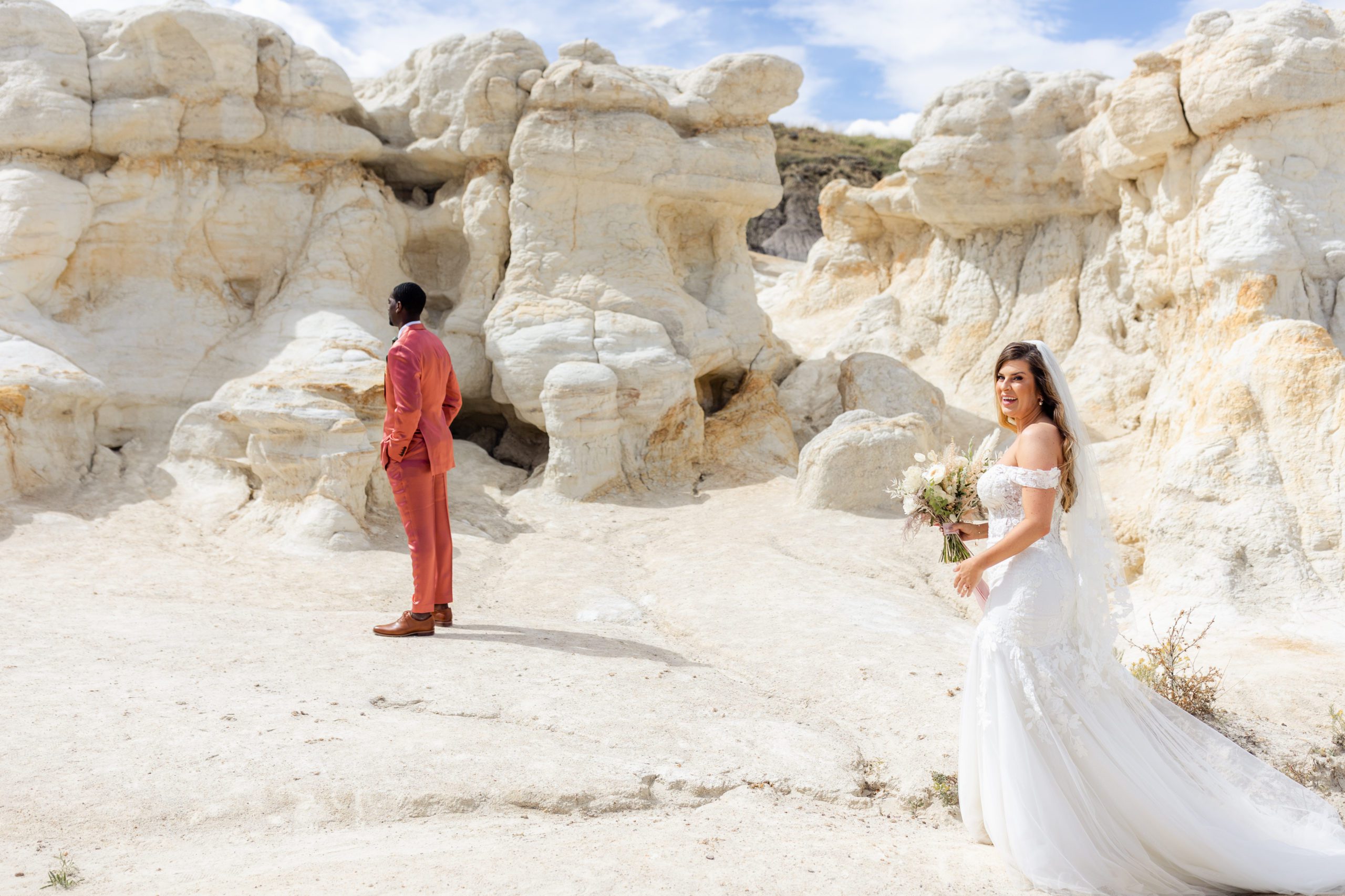 Bride approaches the groom for their first look at the Paint Mines before their elopement at the Garden of the Gods