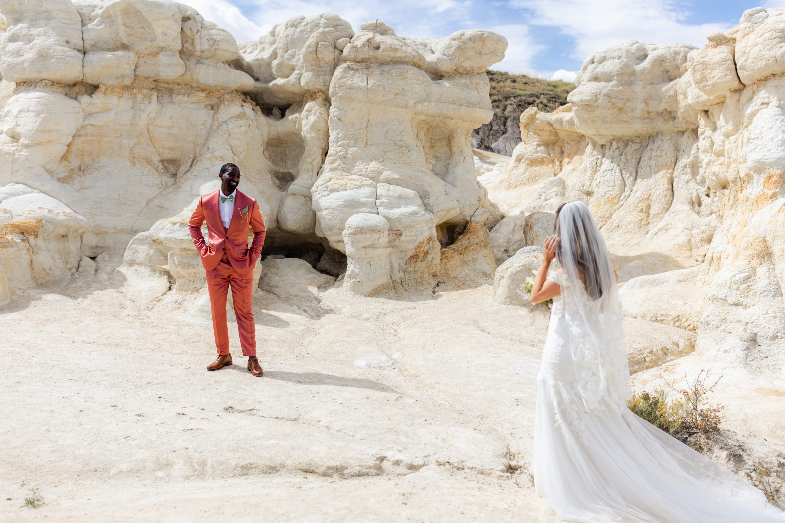 Groom turns to see his bride at the Paint Mines before their elopement at the Garden of the Gods