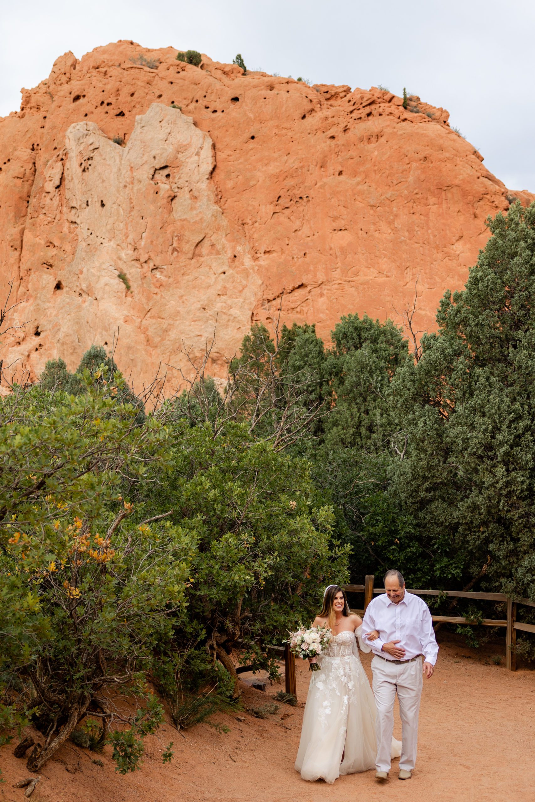 Father of the Bride walks his daughter down the aisle for her elopement at the Garden of the Gods