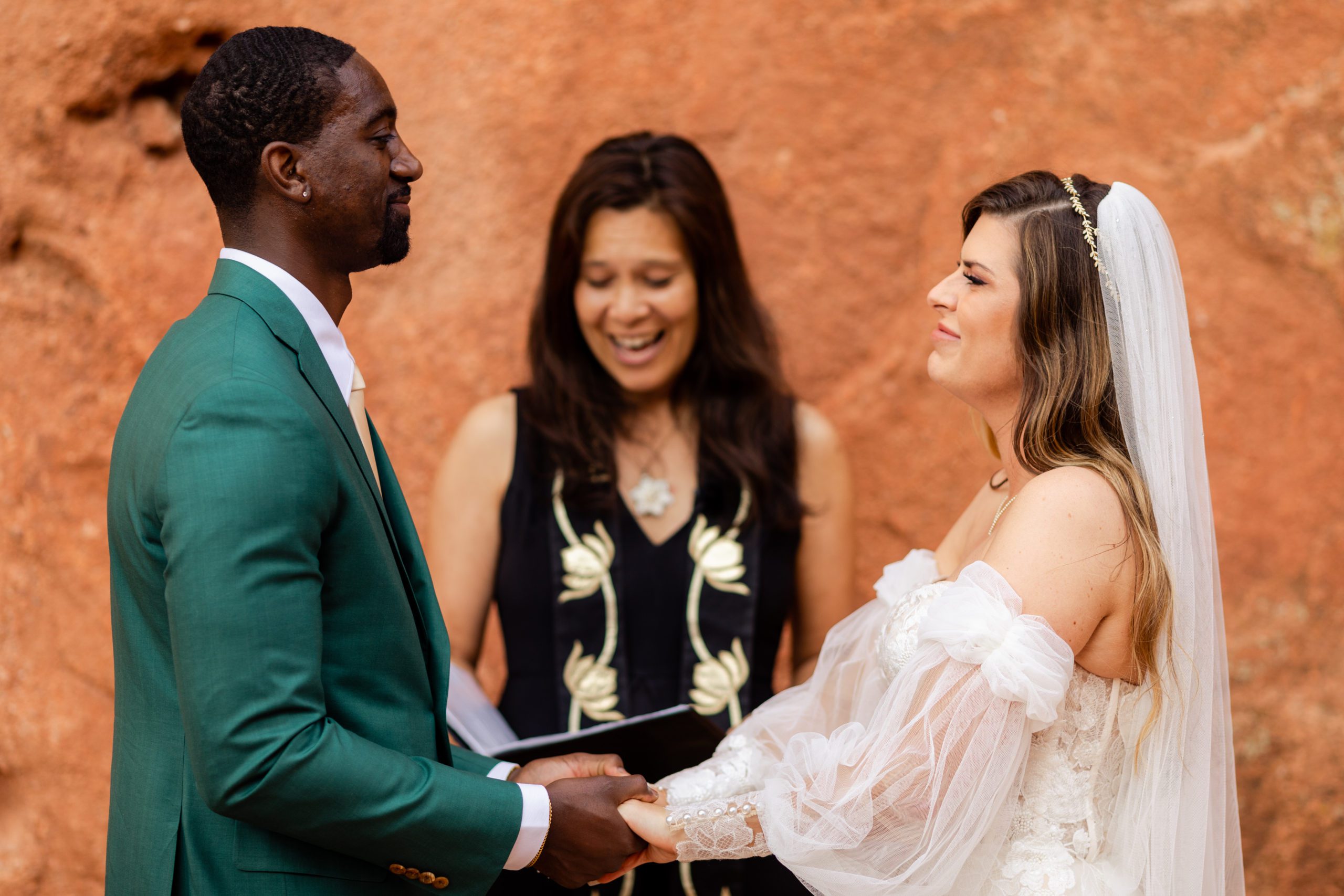 Bride and groom smiles at each other during their elopement ceremony at the Garden of the Gods