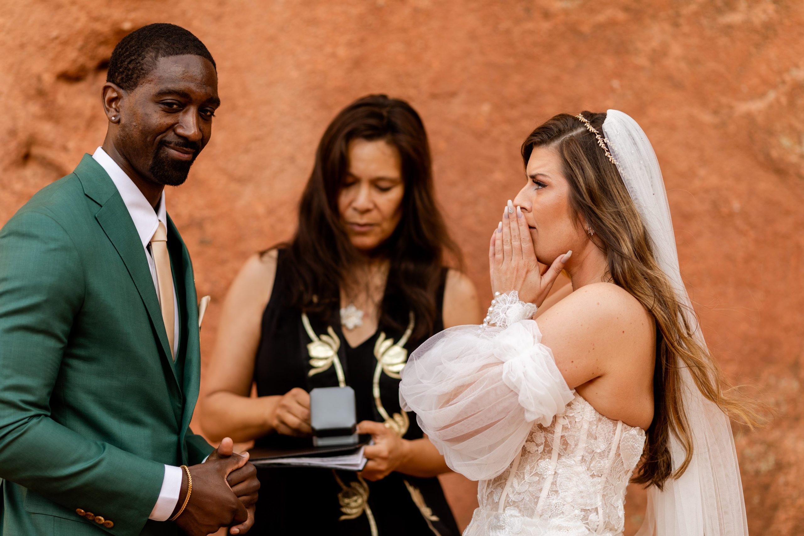 Groom smiles at the Father of the bride after gifting his new bride her dream ring. Bride is shocked! During their elopement at the Garden of the Gods.