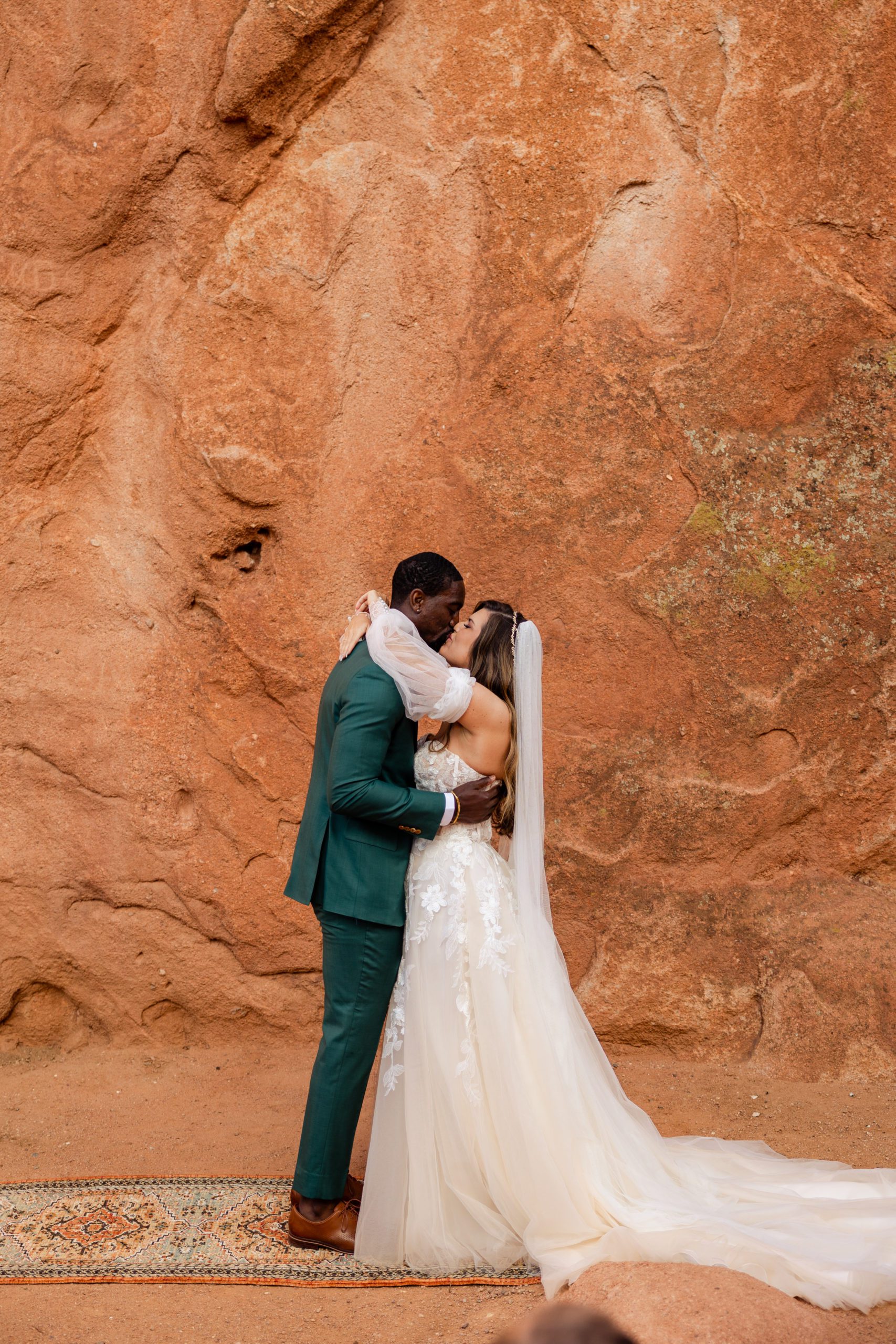 Bride and groom kiss for the first time as husband and wife at their elopement at the Garden of the Gods