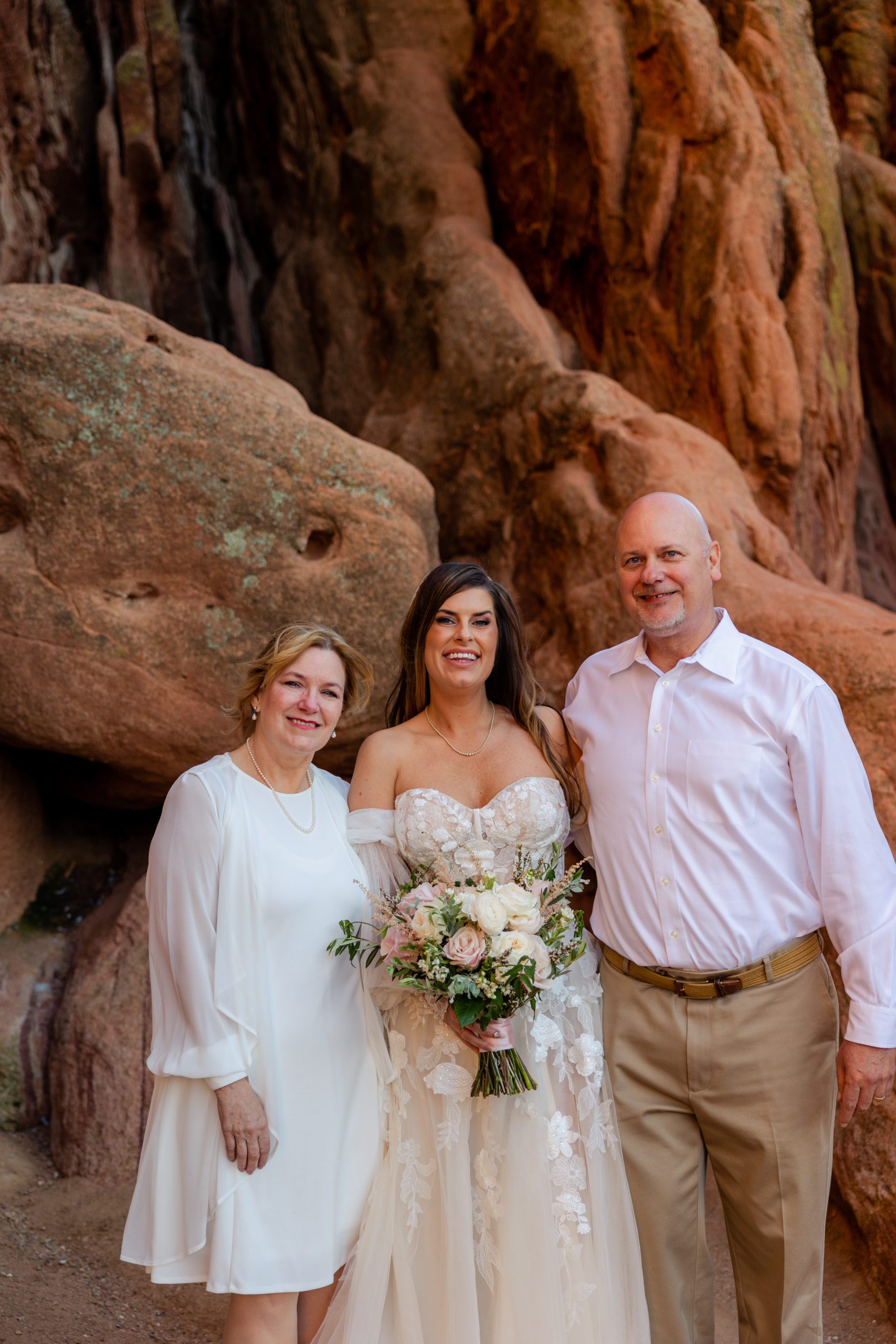 The bride with her Mother and her husband at the garden of the gods. 
