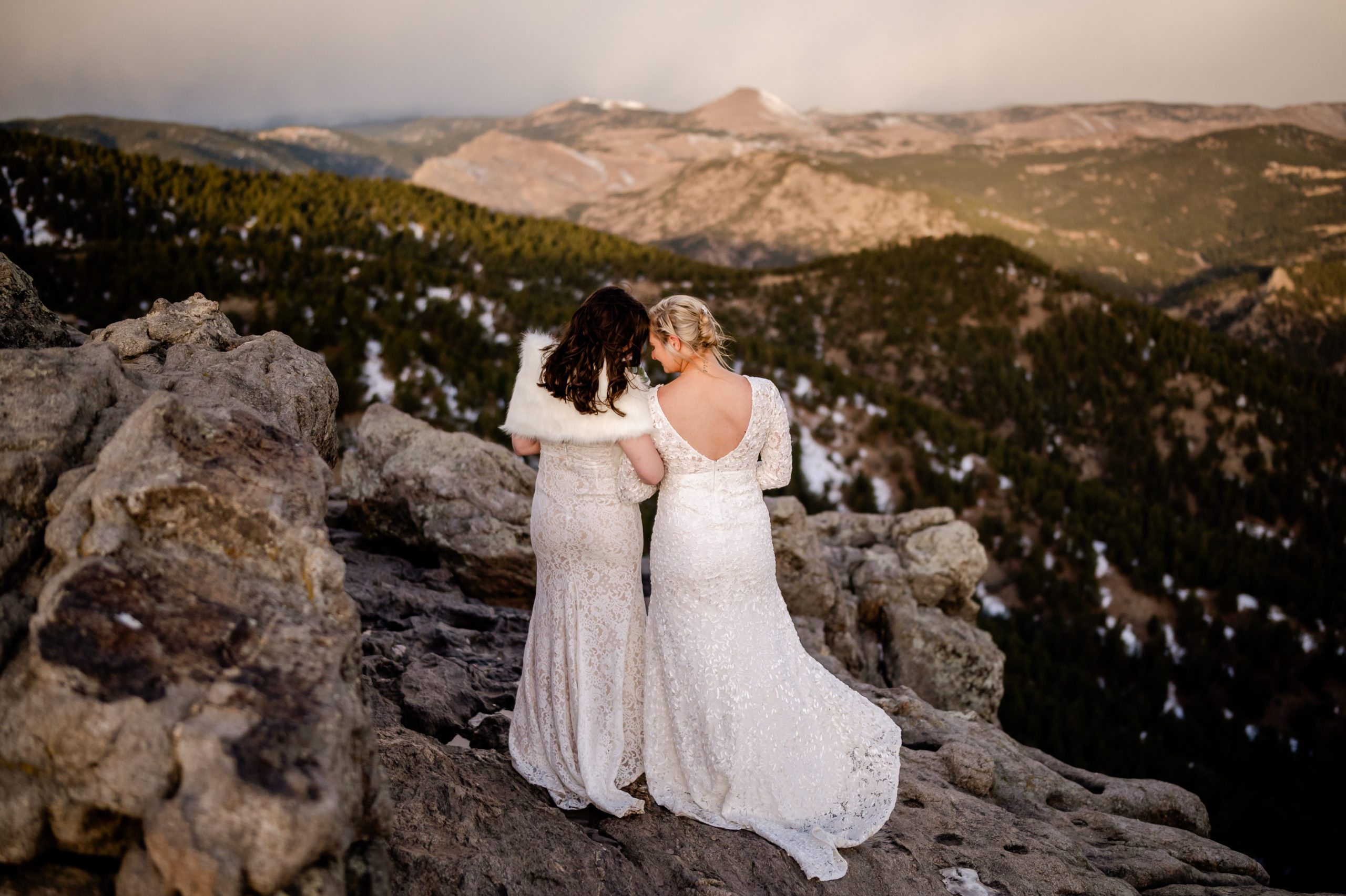 Two brides embracing at Lost Gulch Overlook in Colorado after their sunrise elopement ceremony, Cost to elope