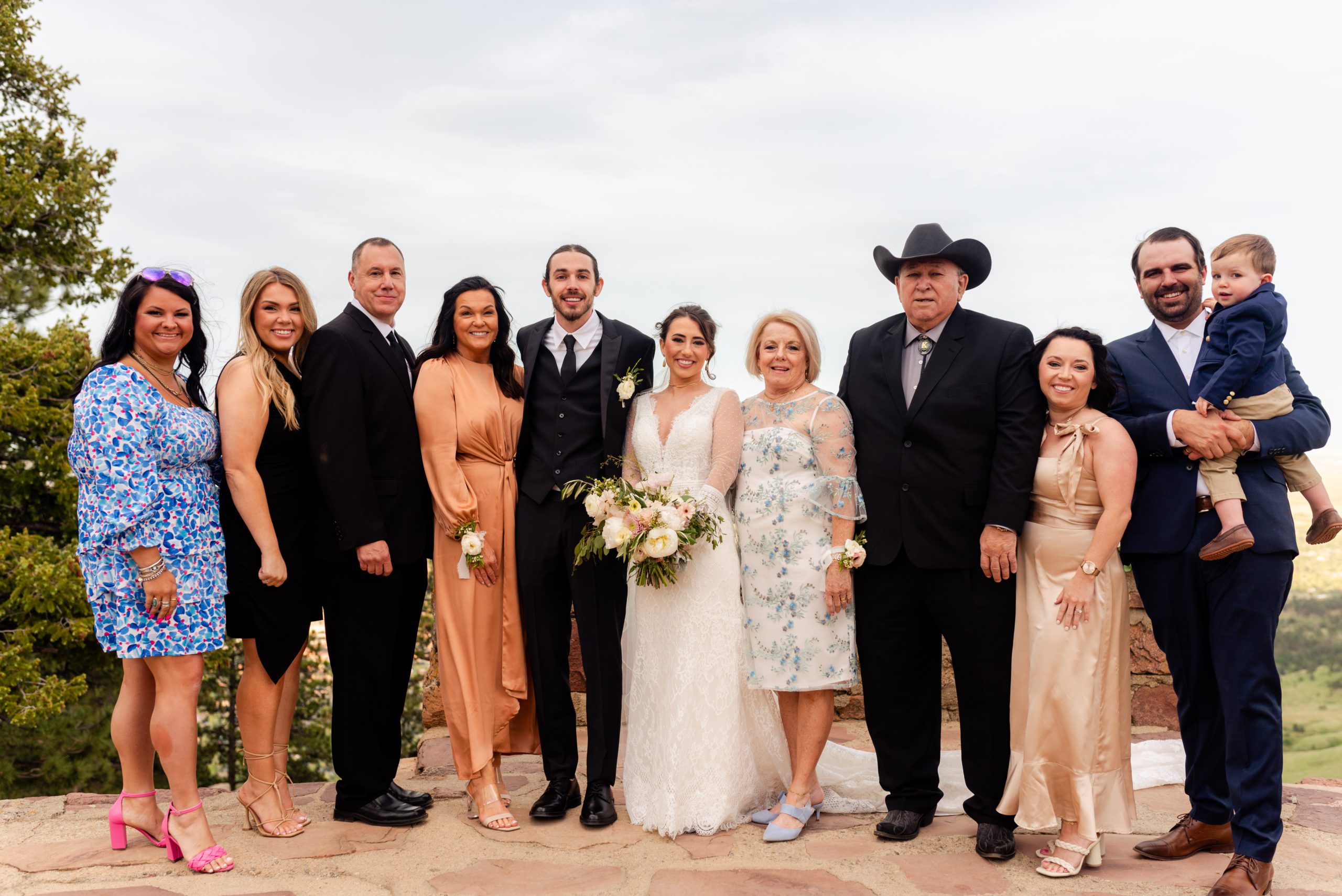 Family shot of guests with bride and groom at Sunrise Amphitheater. 