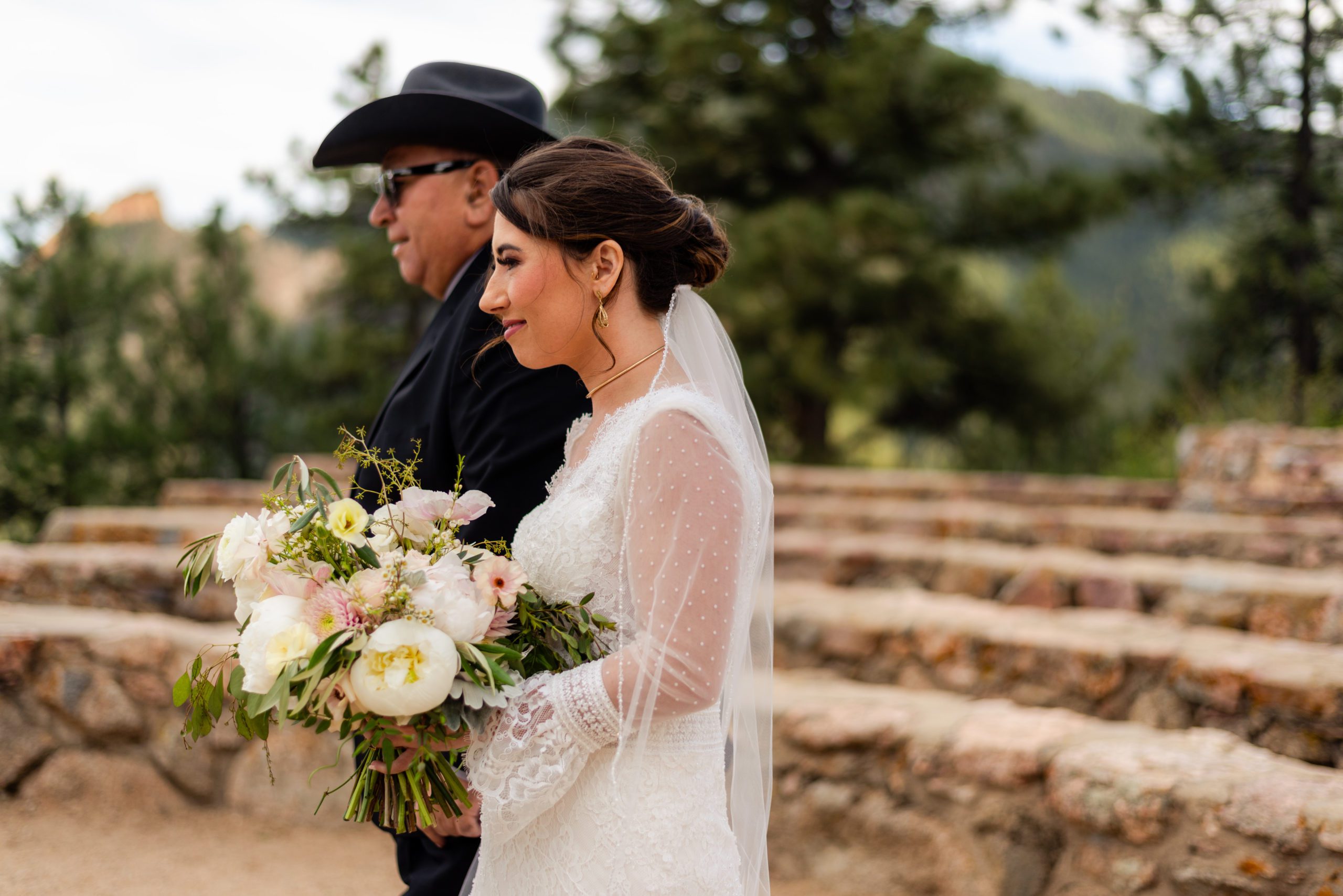 The bride and her father walk together at Sunrise Amphitheater.