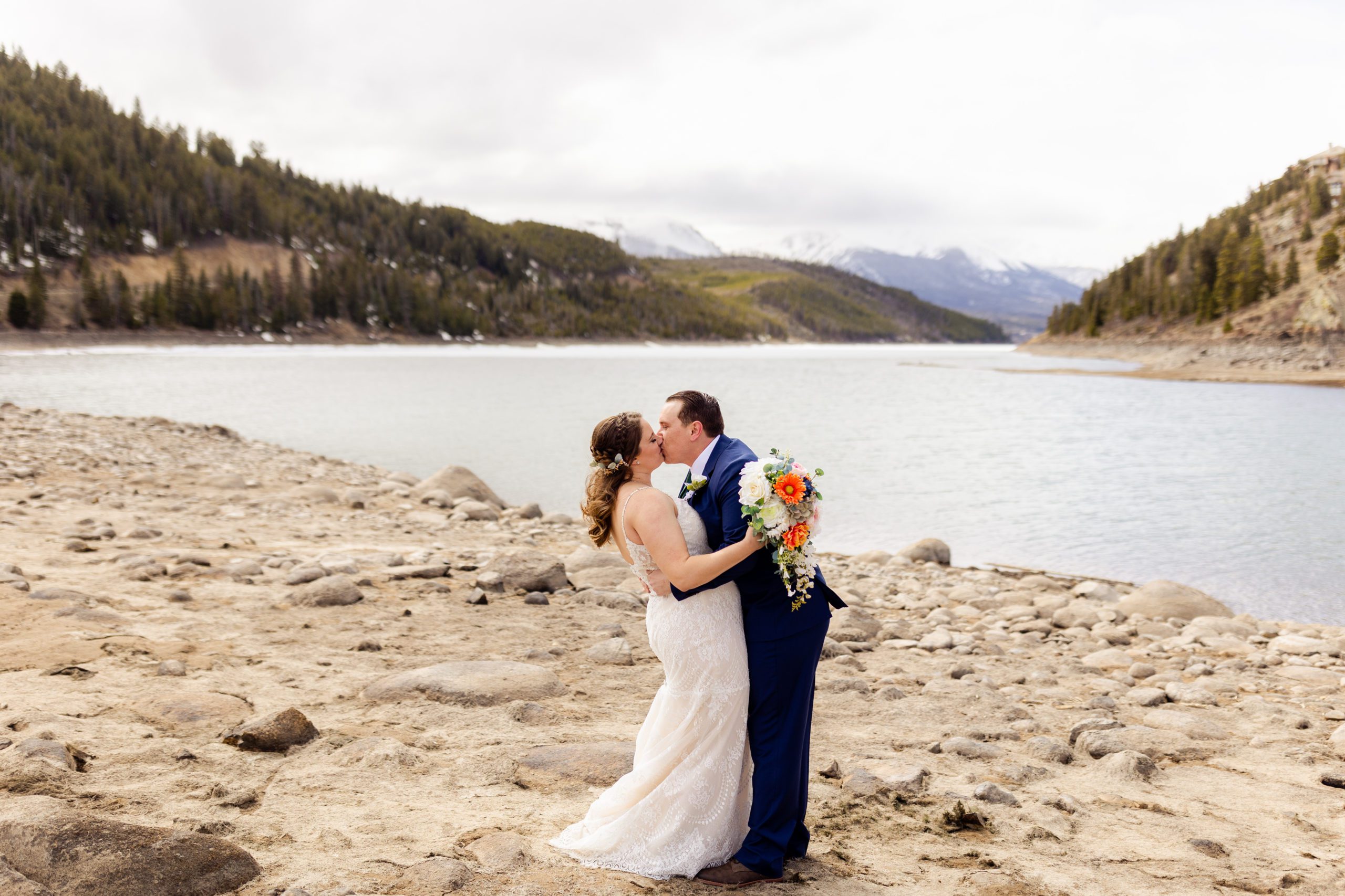 The groom kisses his bride at their Sapphire Point Elopement.