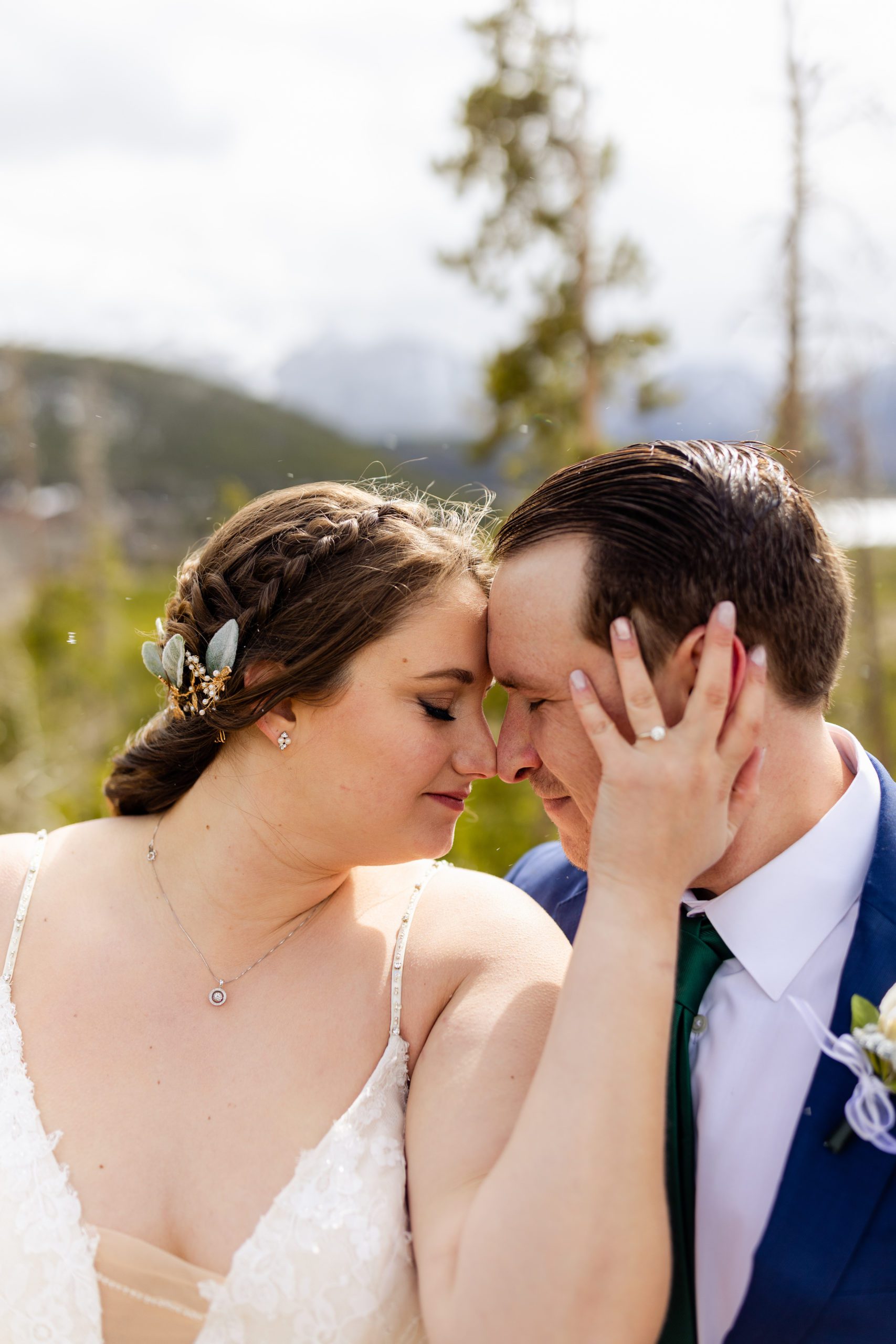 A sweet photo of the bride holding her grooms head before their ceremony at Sapphire Point. 