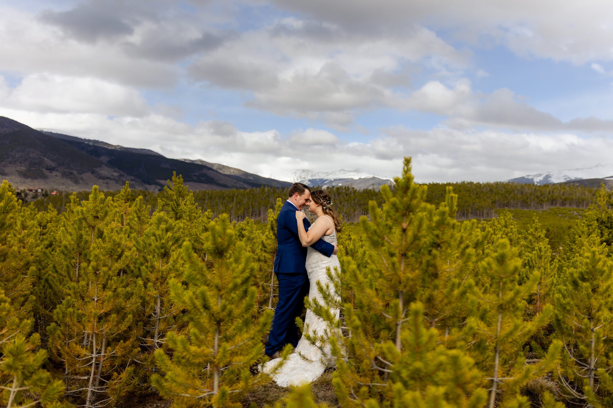The bride and groom amongst the beautiful fir trees right before their Sapphire Point Elopement ceremony. 