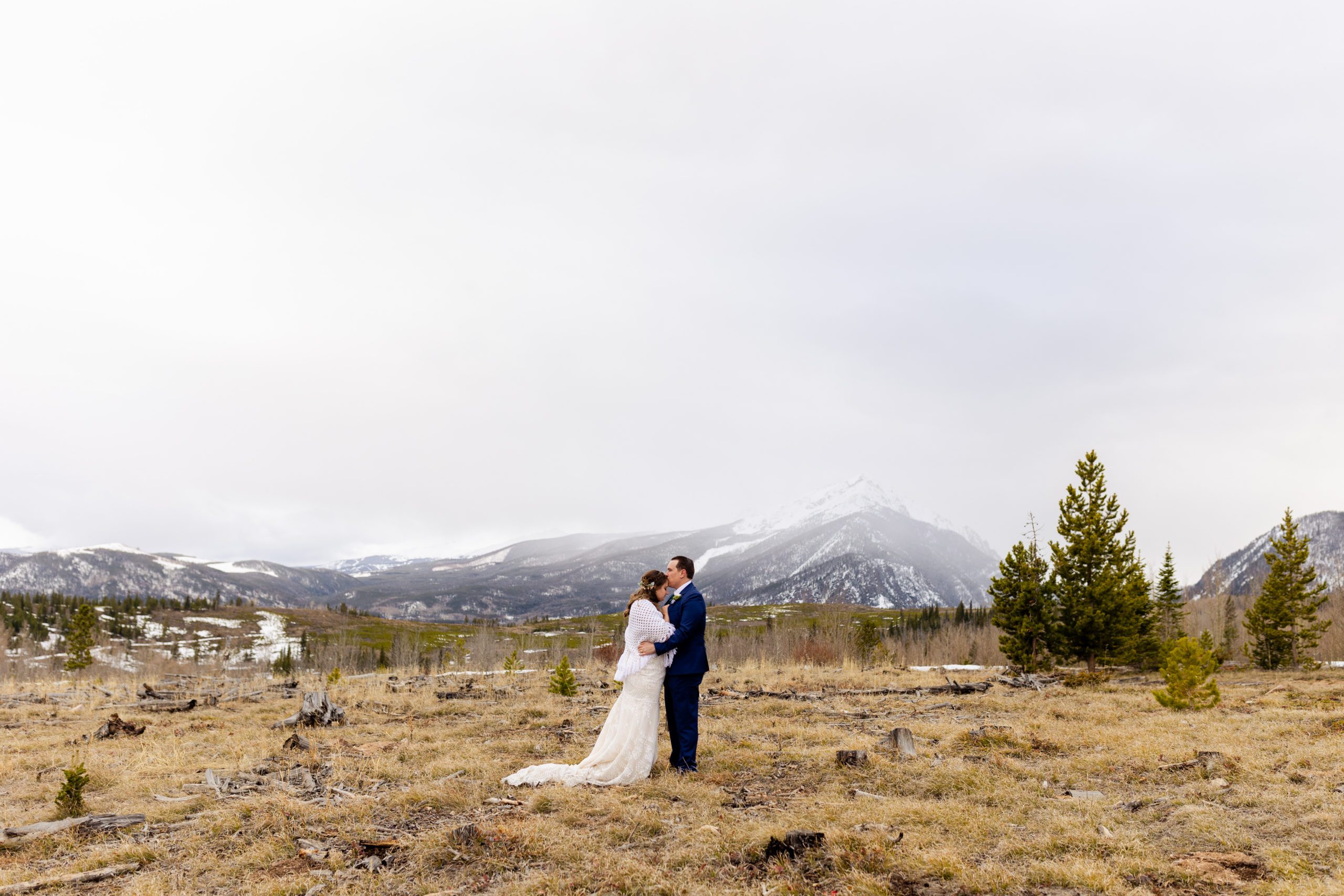 A wide shot of the bride and groom at loveland pass at their Sapphire Point Elopement.