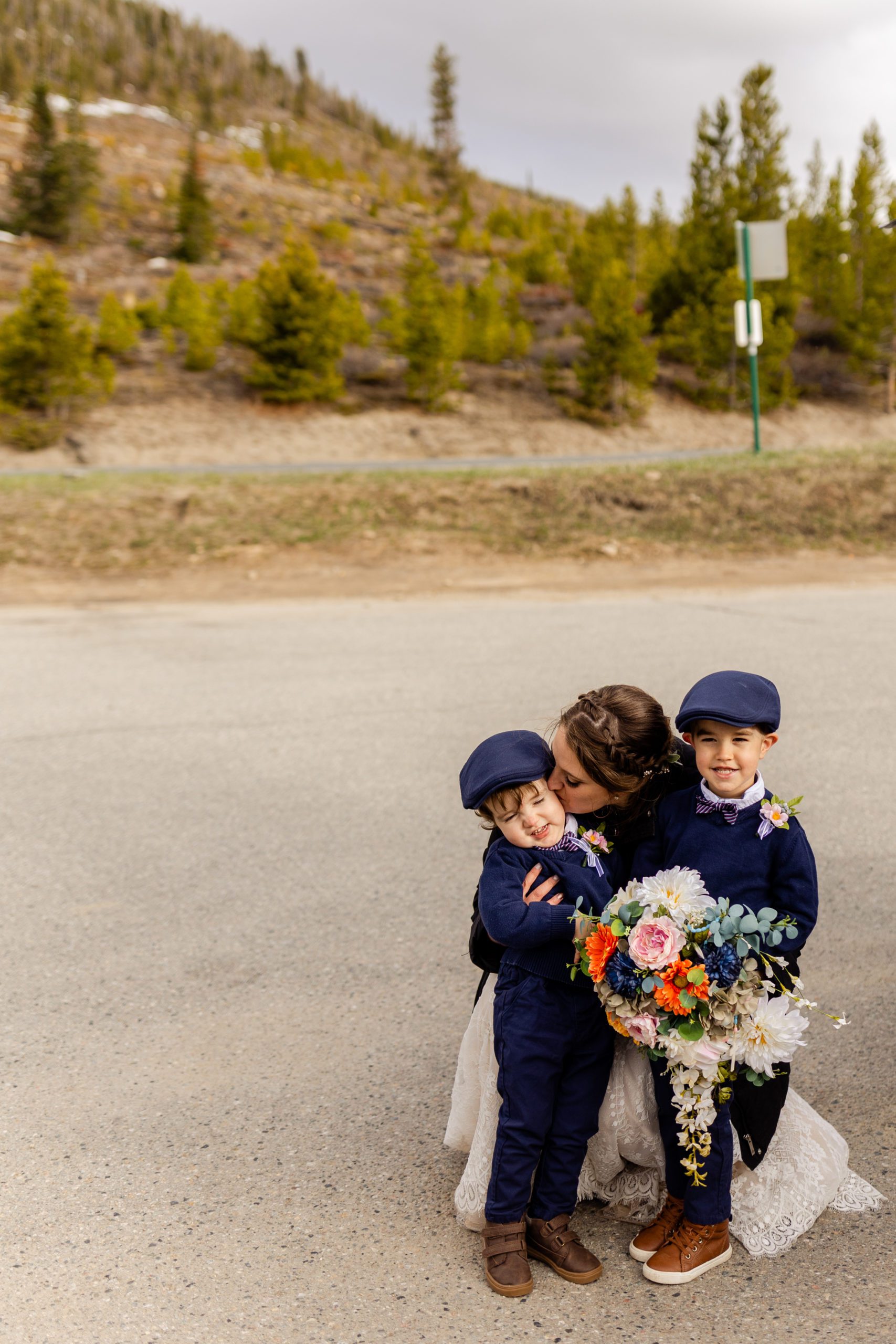 The bride sweetly kisses her nephews on the cheek at her Sapphire Point Elopement.