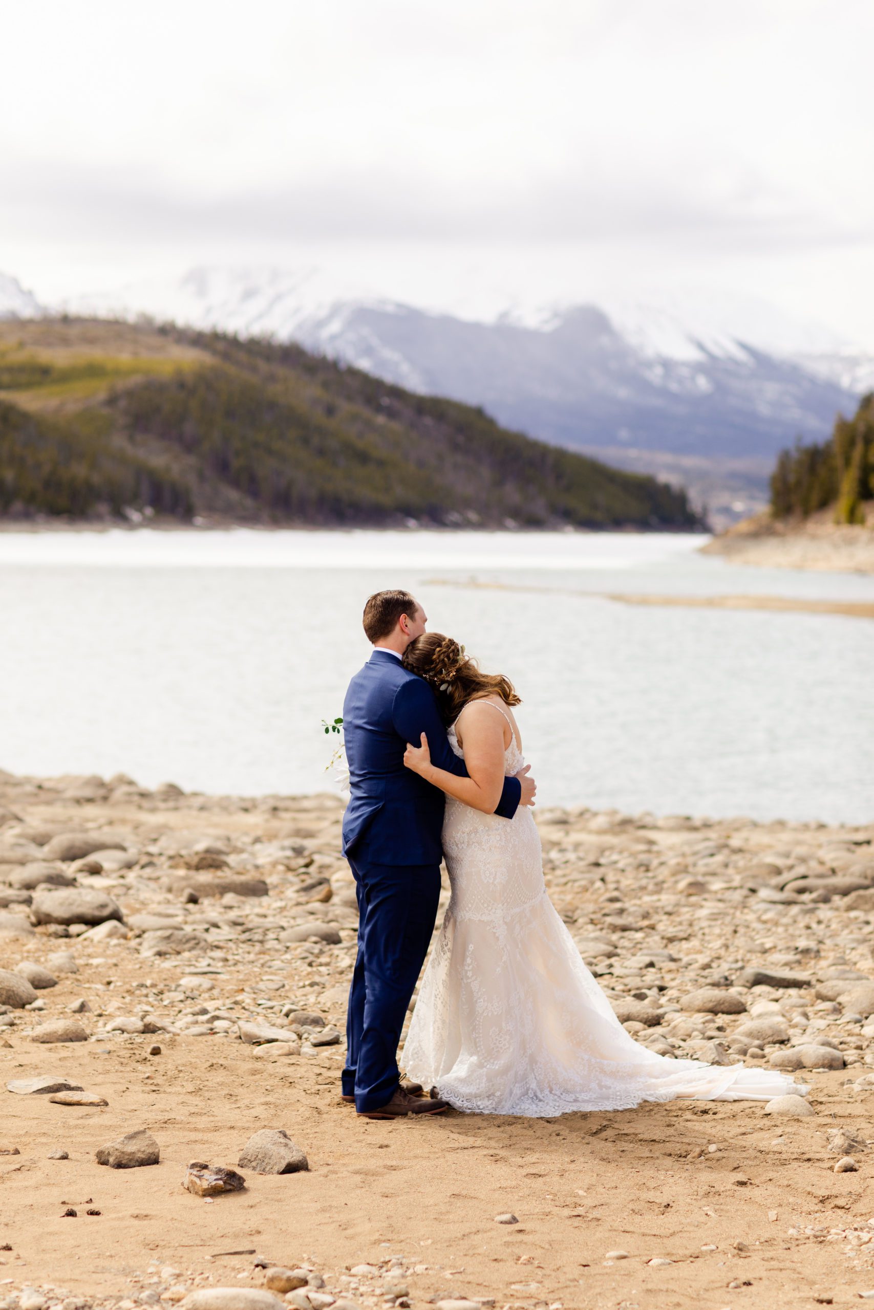 Bride rests her head on her grooms shoulder - before their Sapphire Point Elopement.
