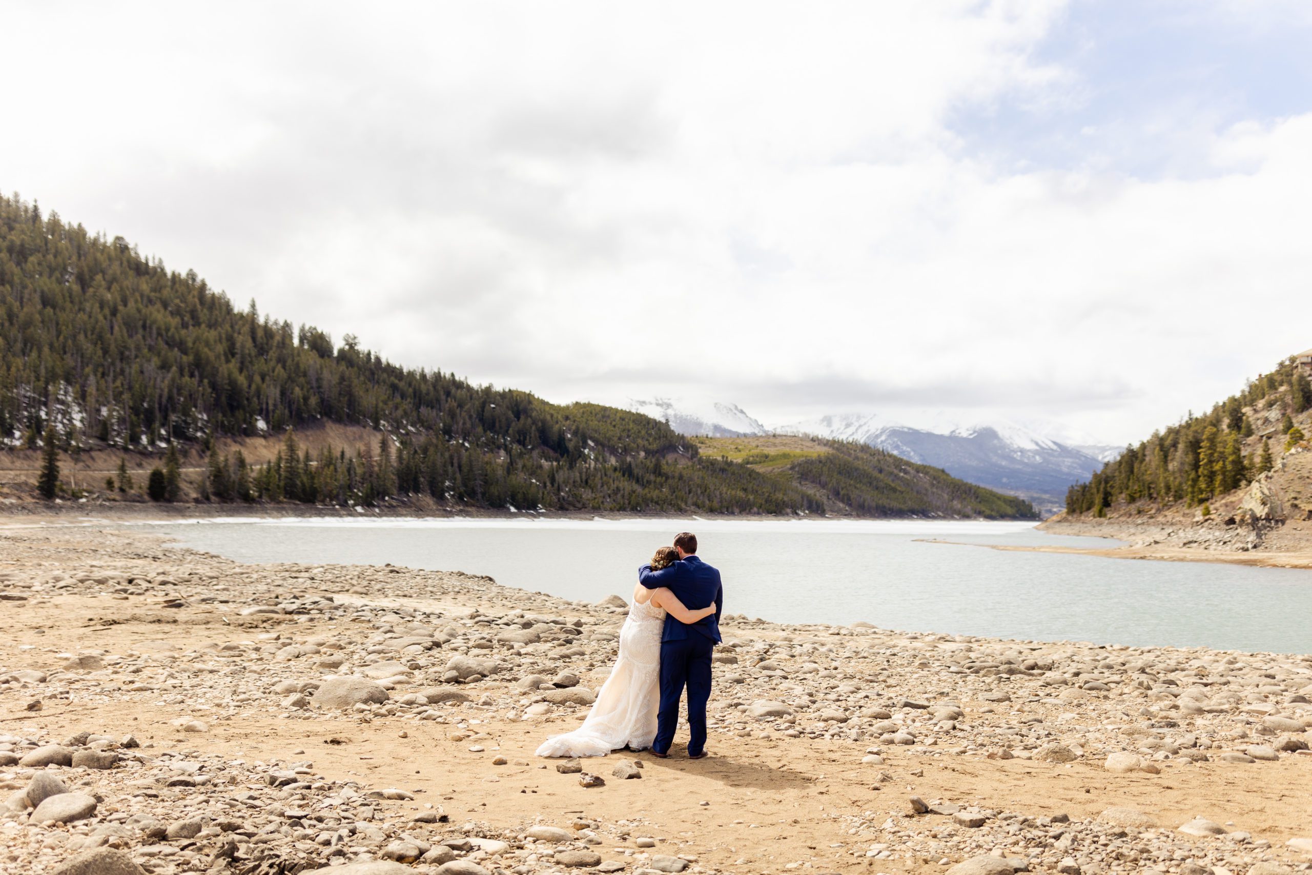 Groom puts his arm over his bride's shoulder before their Sapphire Point Elopement.