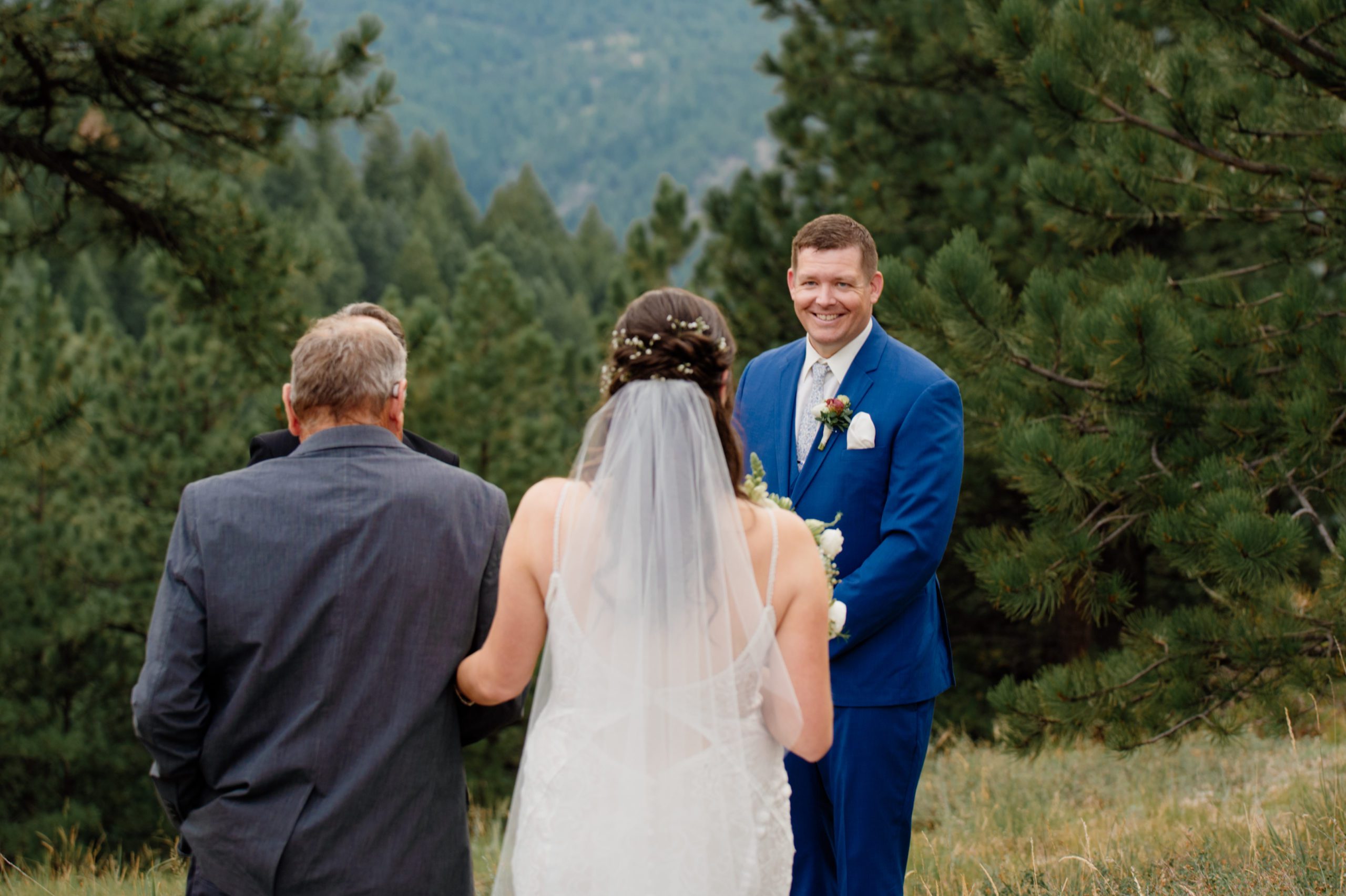 The bride walks down the aisle with her father during her artist point elopement. 