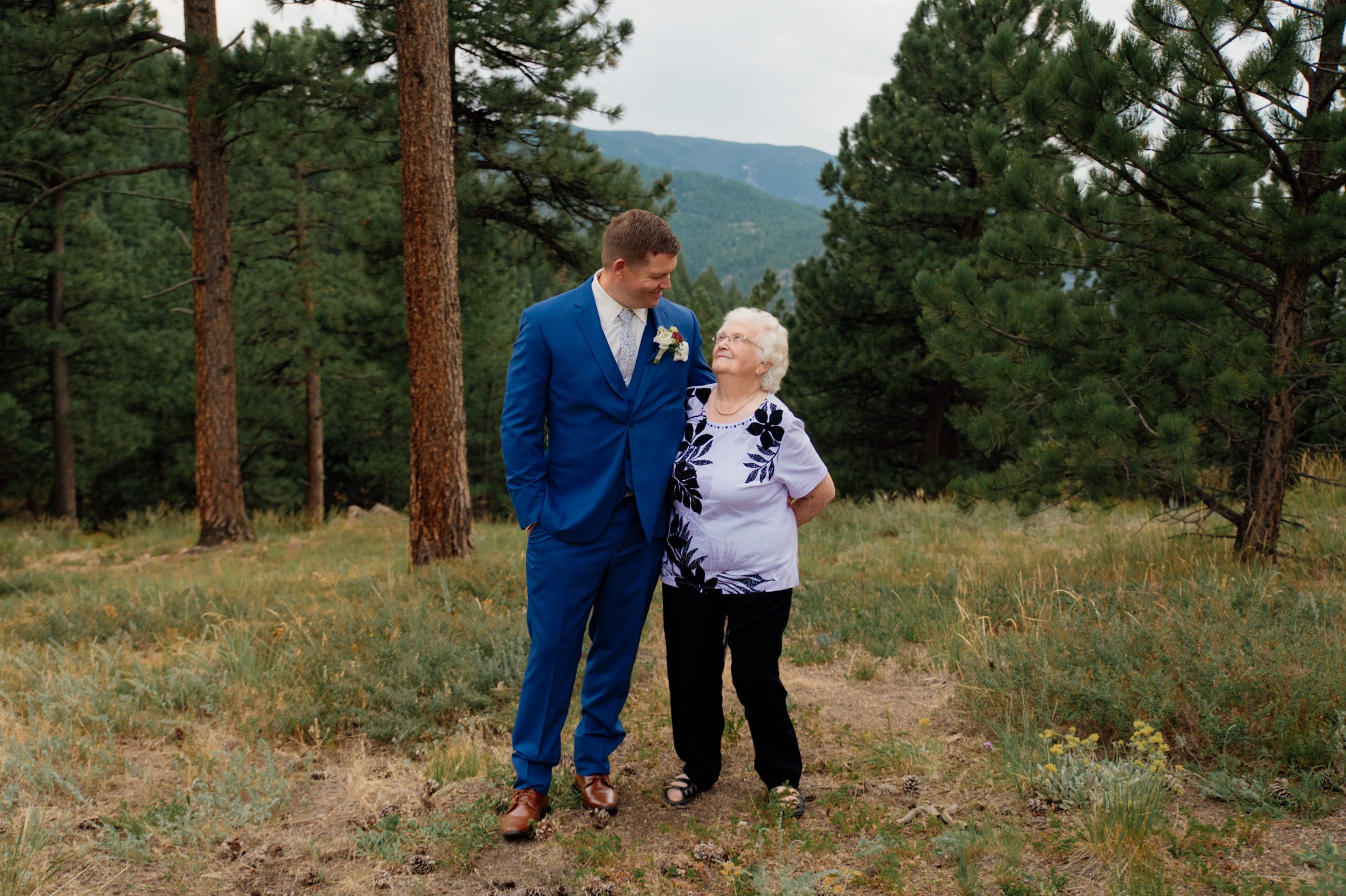 The groom and his sweet 91 year old grandma standing side-by-side and smiling at each other after the grooms artist point elopement. 