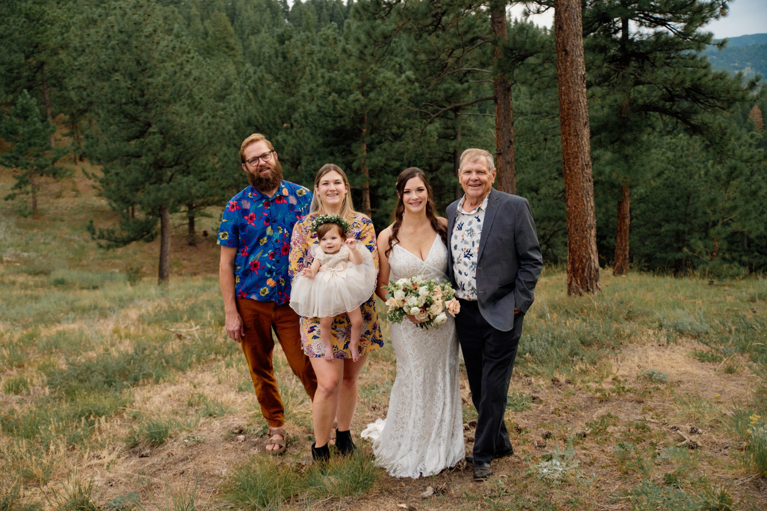 A family shot of with the bride and groom at their artist point elopement 