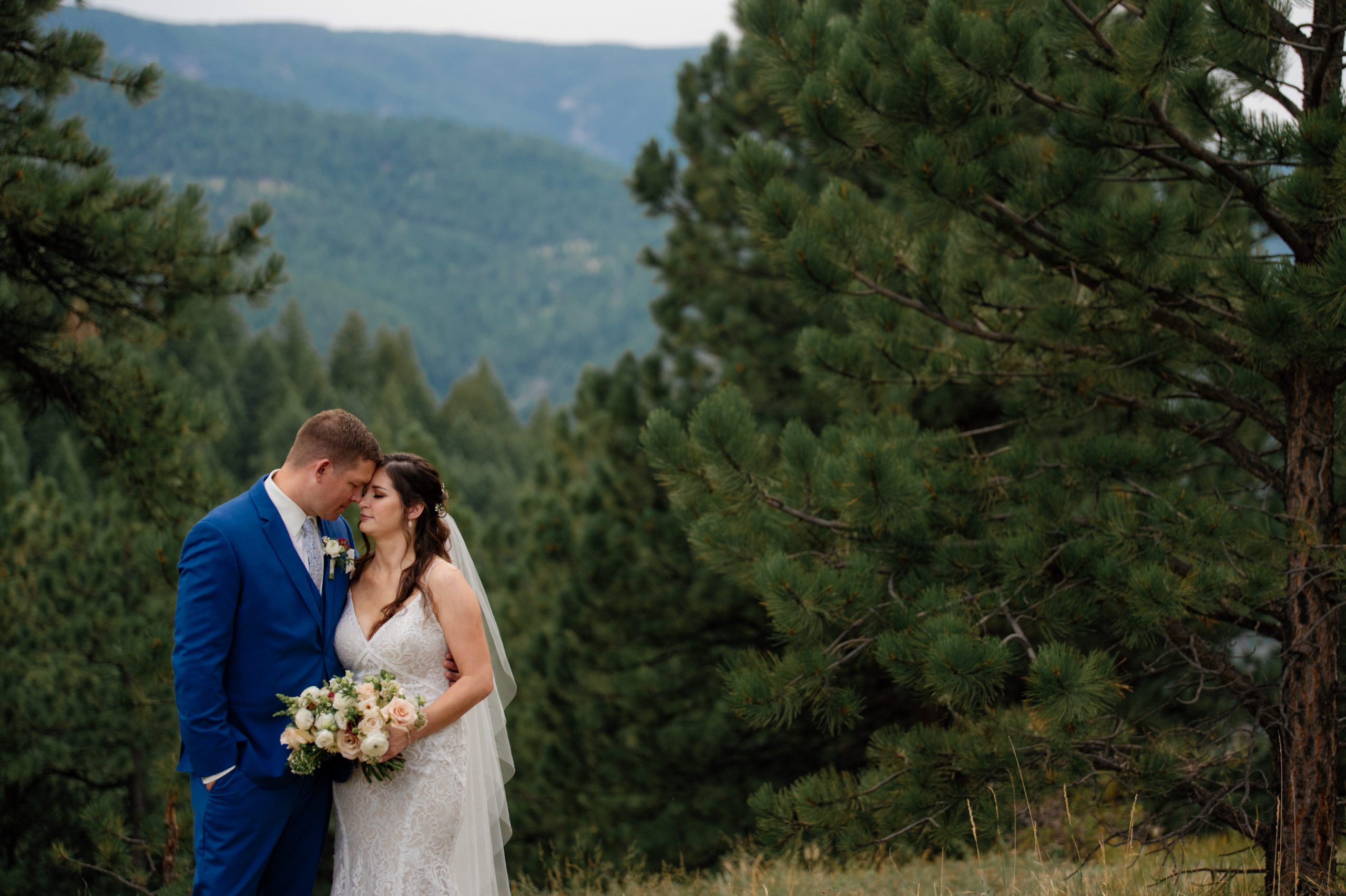 the bride and groom nuzzle heads in love after their elopement at artist point. 
