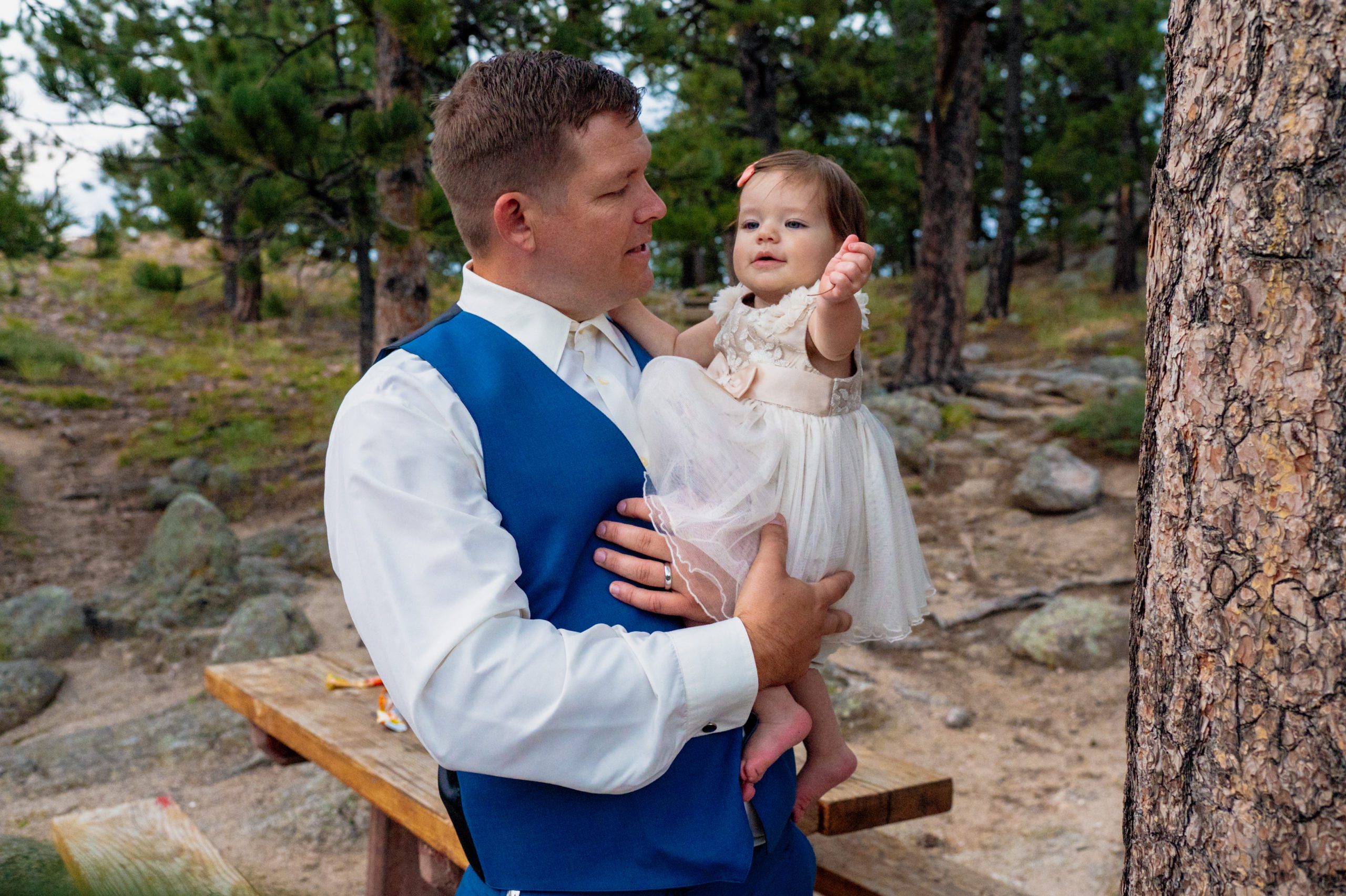 The groom holding his adorable little daughter after his artist point elopement. 