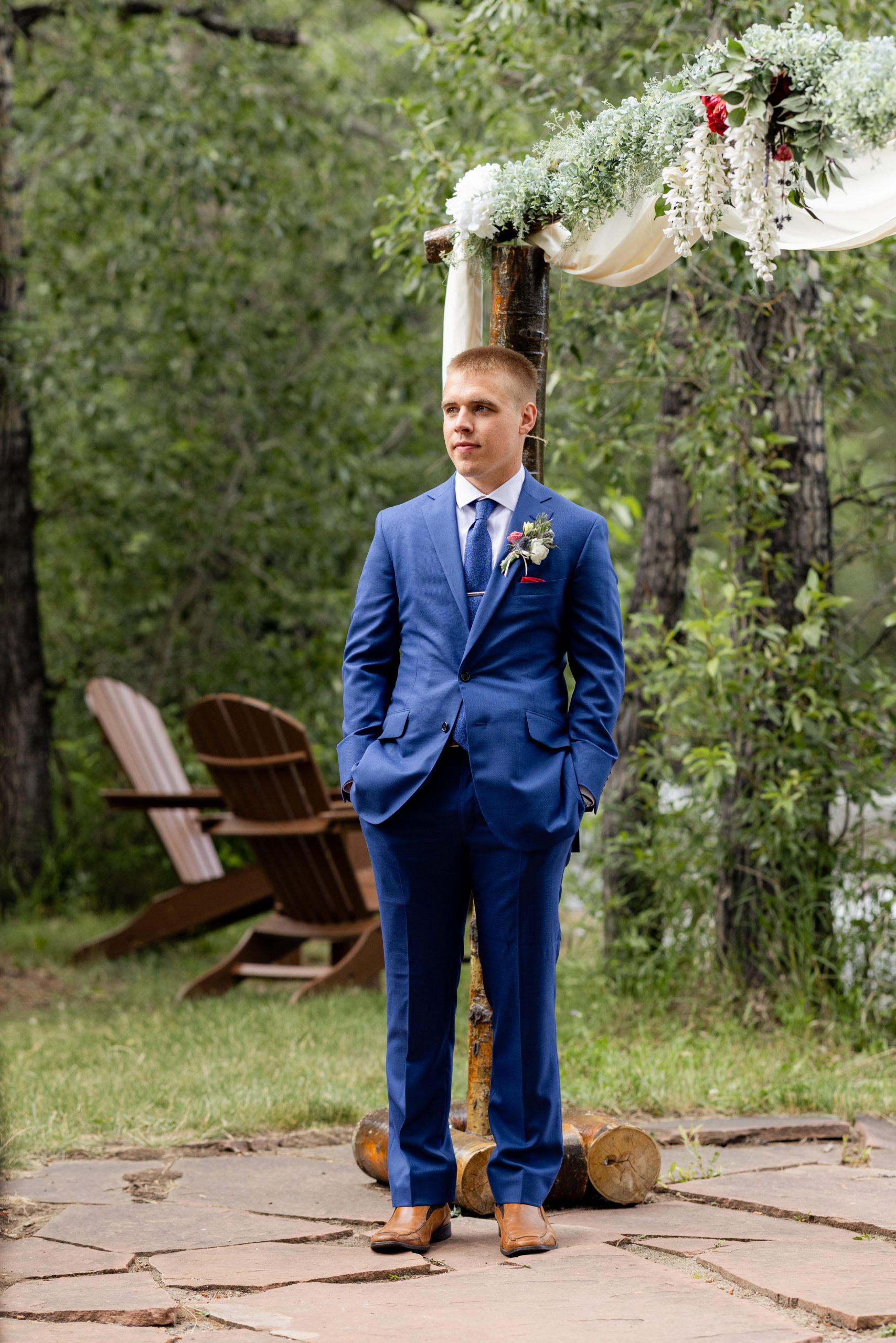 The groom waits patiently for his bride at the altar at Romantic RiverSong Inn in Estes Park on their wedding day. 