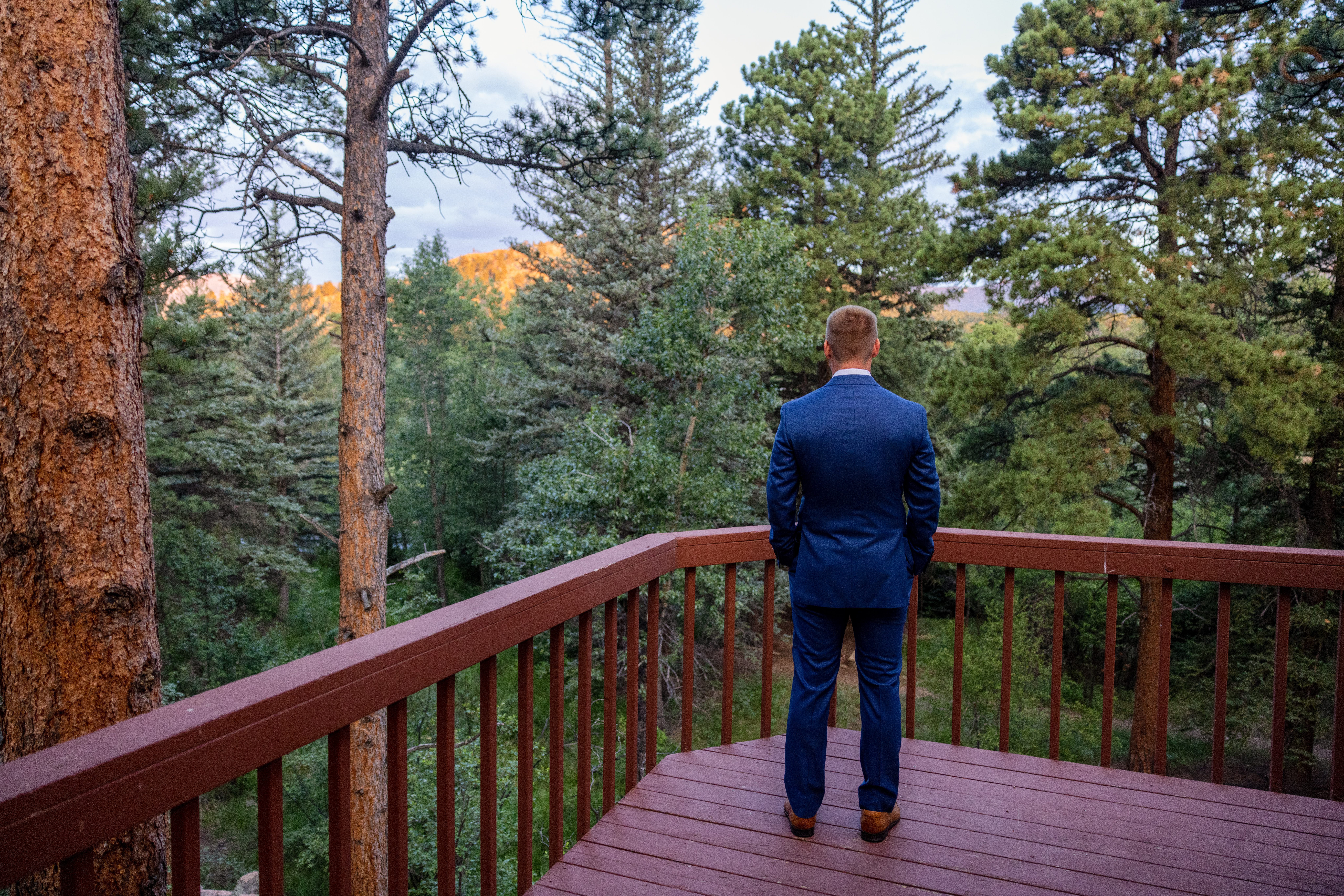 The groom waits for his bride for their first look at Romantic RiverSong Inn in Estes Park on their wedding day