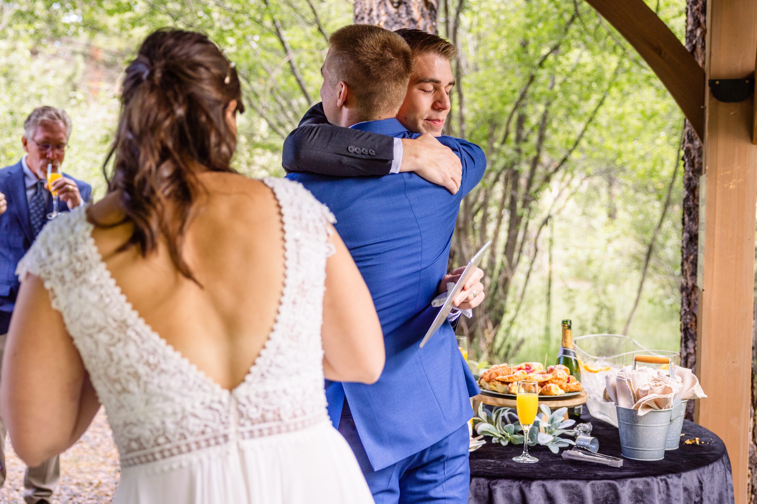 The groom and his brother hug, at their reception at Romantic RiverSong Inn in Estes Park. 