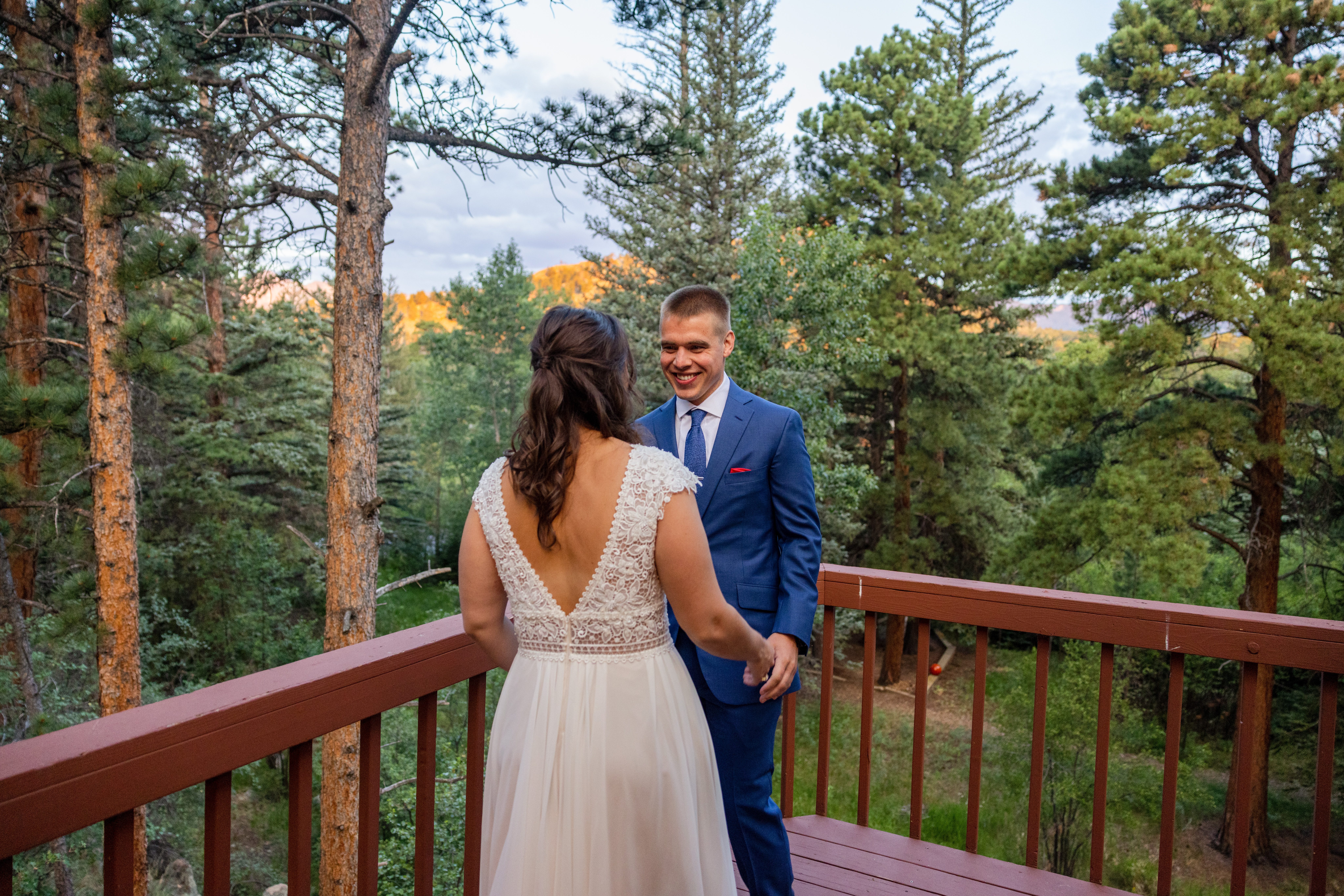 The bride and groom share a first look on their wedding day at Romantic RiverSong Inn in Estes Park