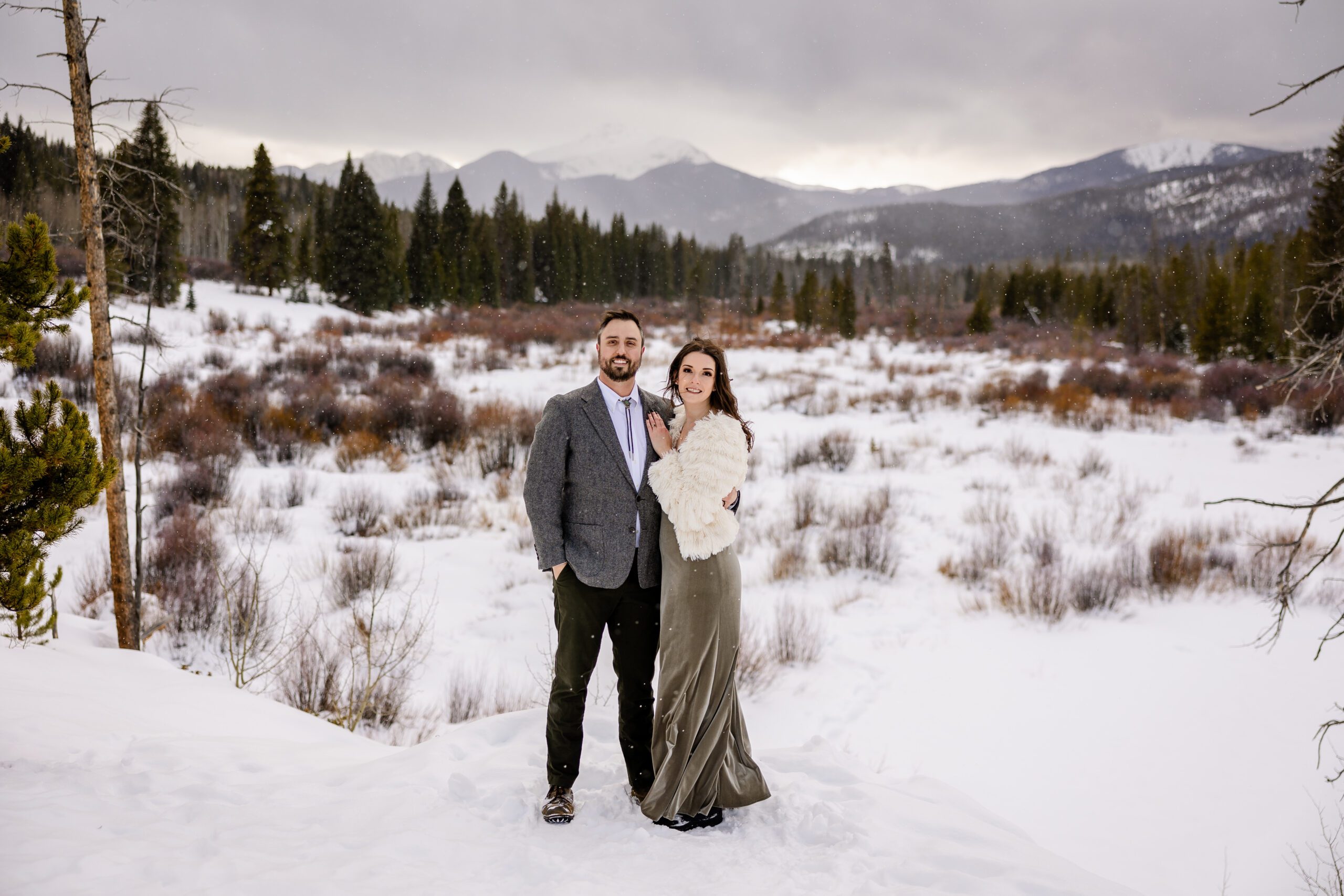 The bride and groom holding each other and smiling at the camera a their Winter Park elopement.