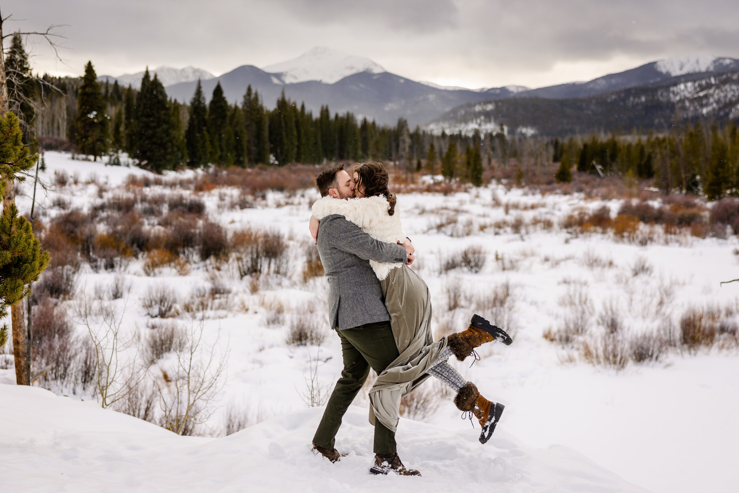 the bride and groom kissing, the groom holding her up with his arms around her at their Winter Park elopement.