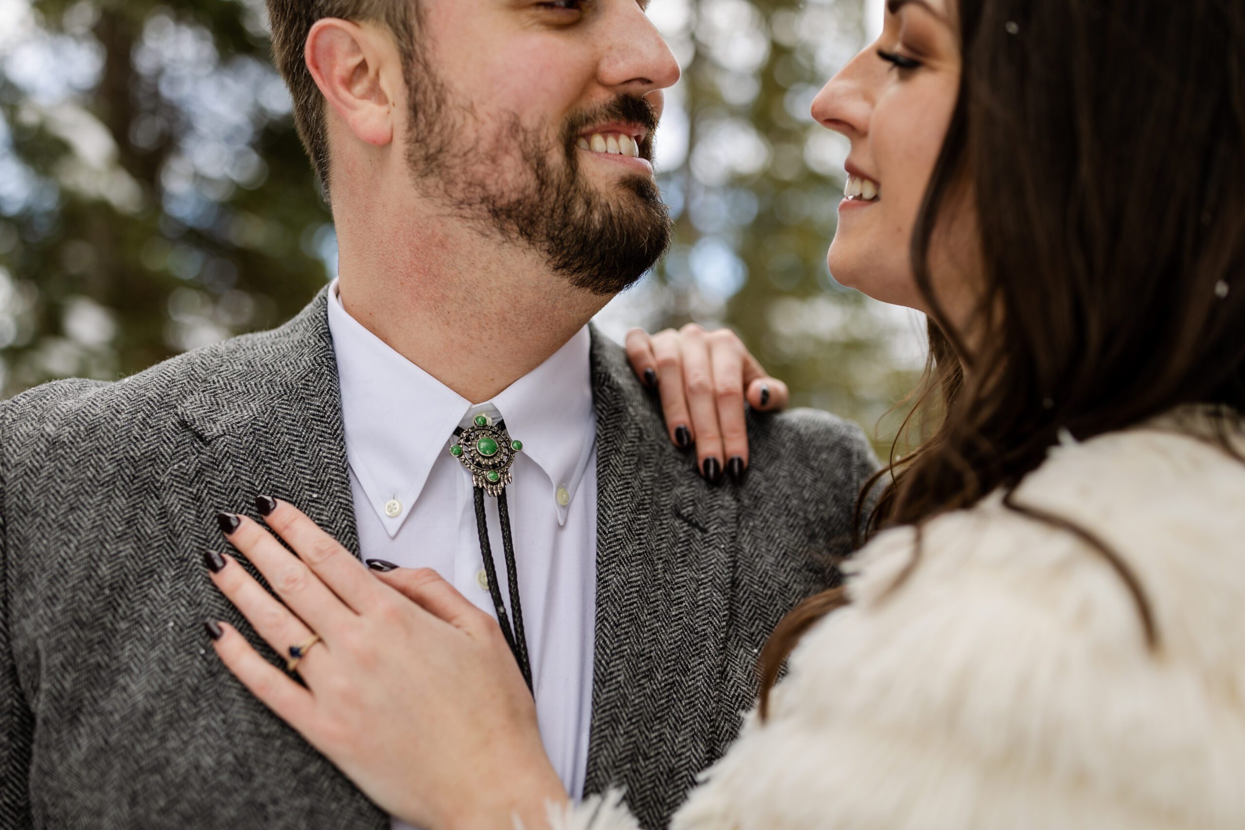 an upclose shot of the bride and groom smiling at each other, a shot of her ring at their Winter Park elopement.