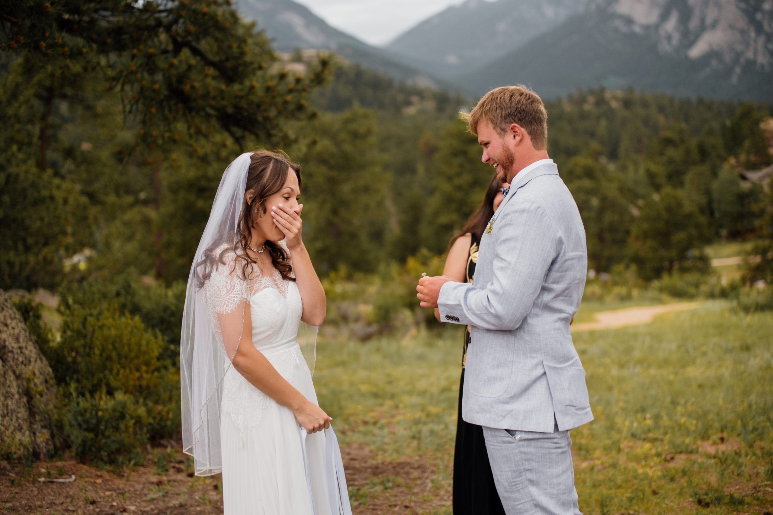 The groom surprises his bride with a gorgeous ring during their elopement ceremony at Knoll Willows in Estes Park.