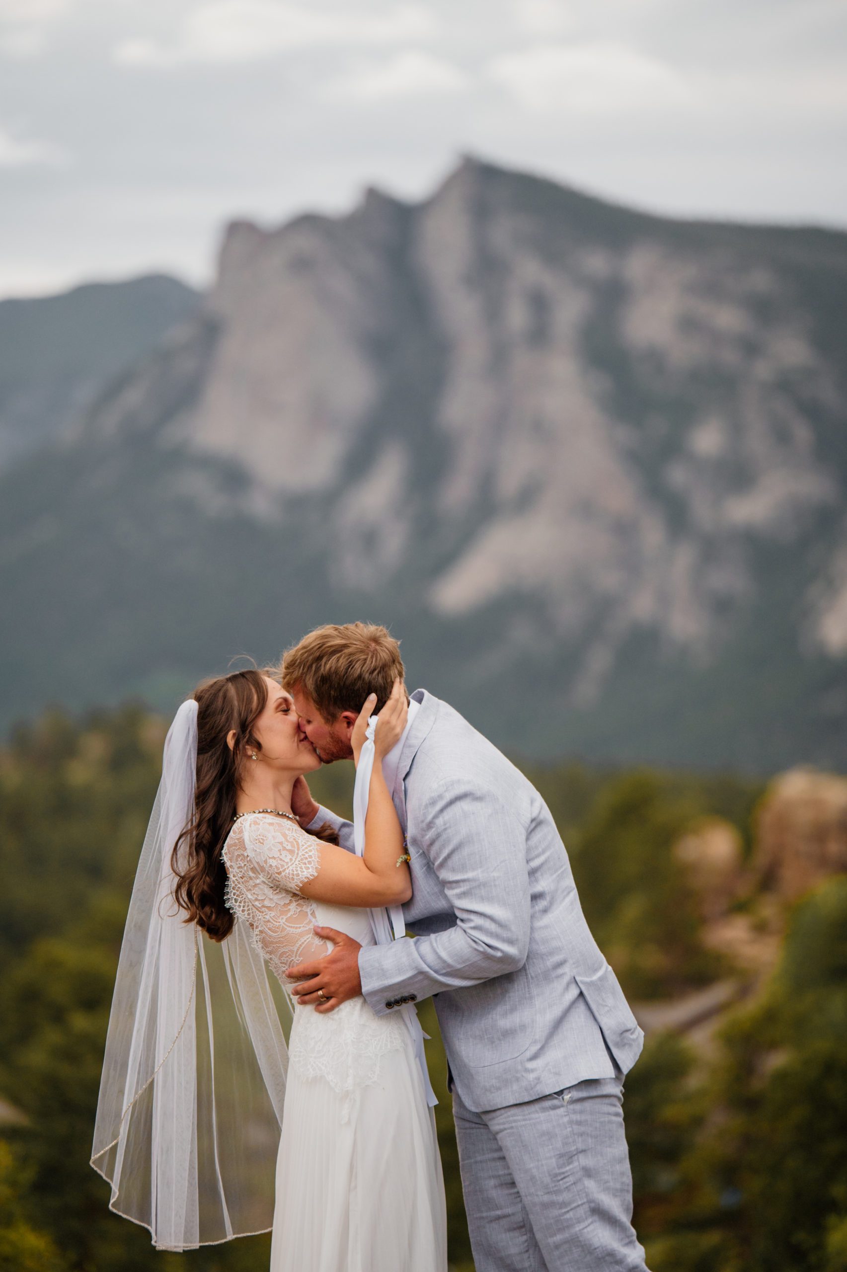 The bride and groom kiss for the first time as husband and wife after their elopement ceremony at Knoll Willows in Estes Park.