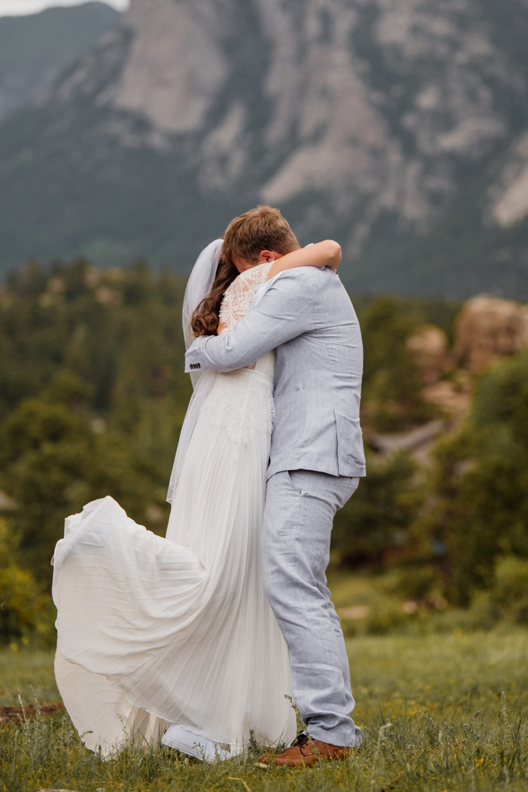 The bride and groom embrace after their elopement ceremony at Knoll Willows in Estes Park.