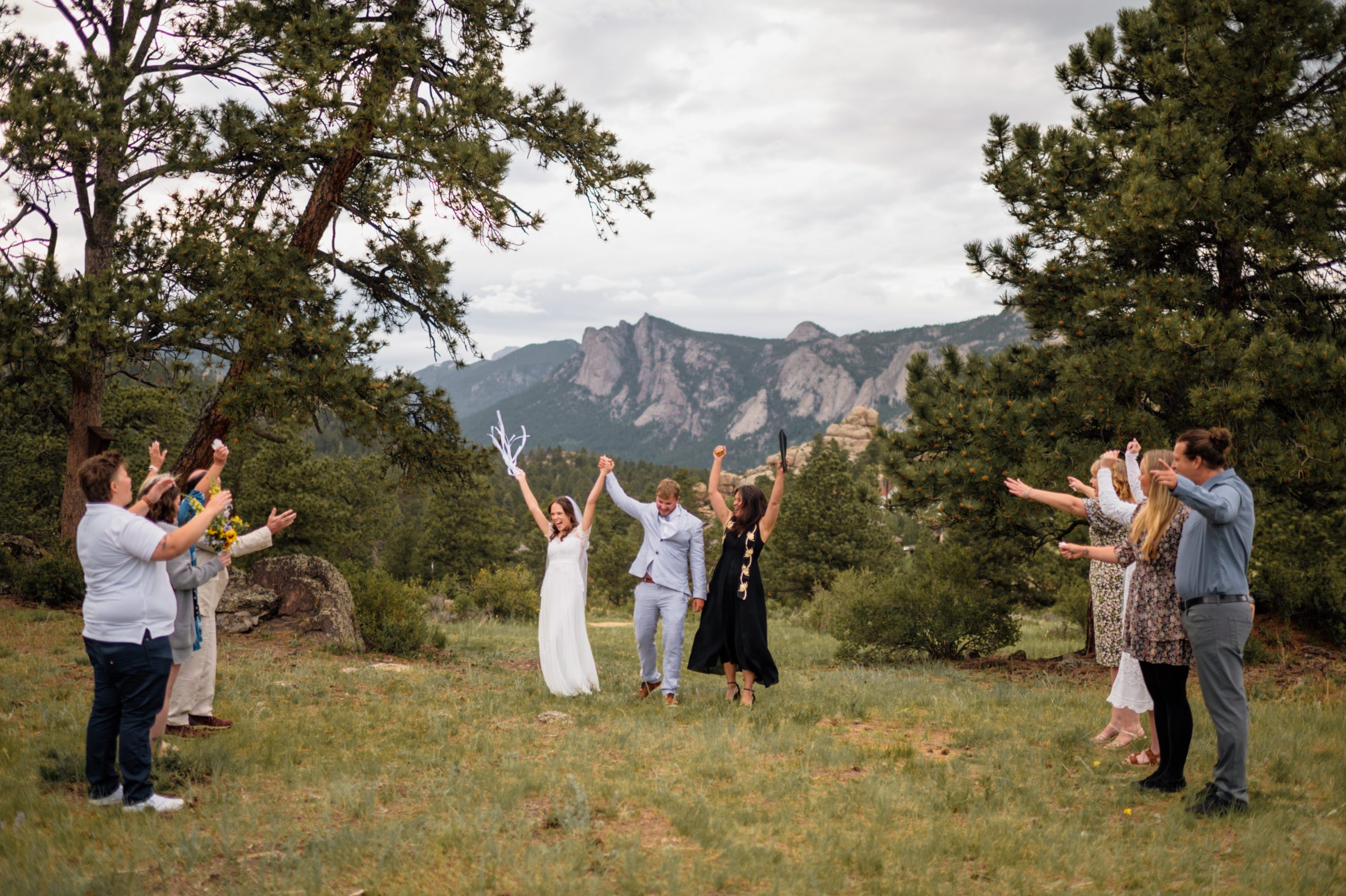 The bride and groom in celebration after their elopement ceremony at Knoll Willows in Estes Park.