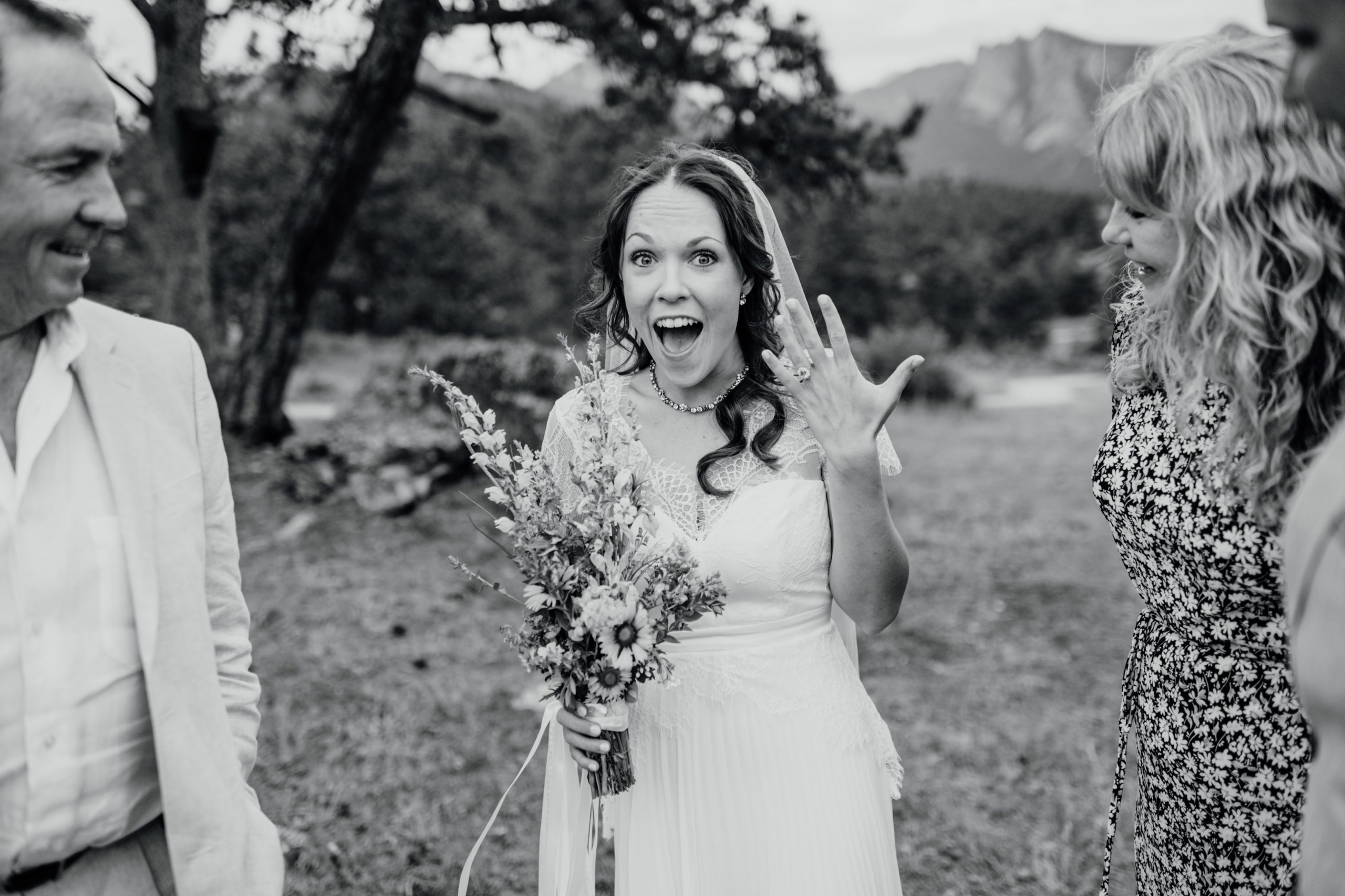 A gorgeous photo of the bride in black and white, showing off her ring after her Knoll Willows elopement ceremony in Estes park. 