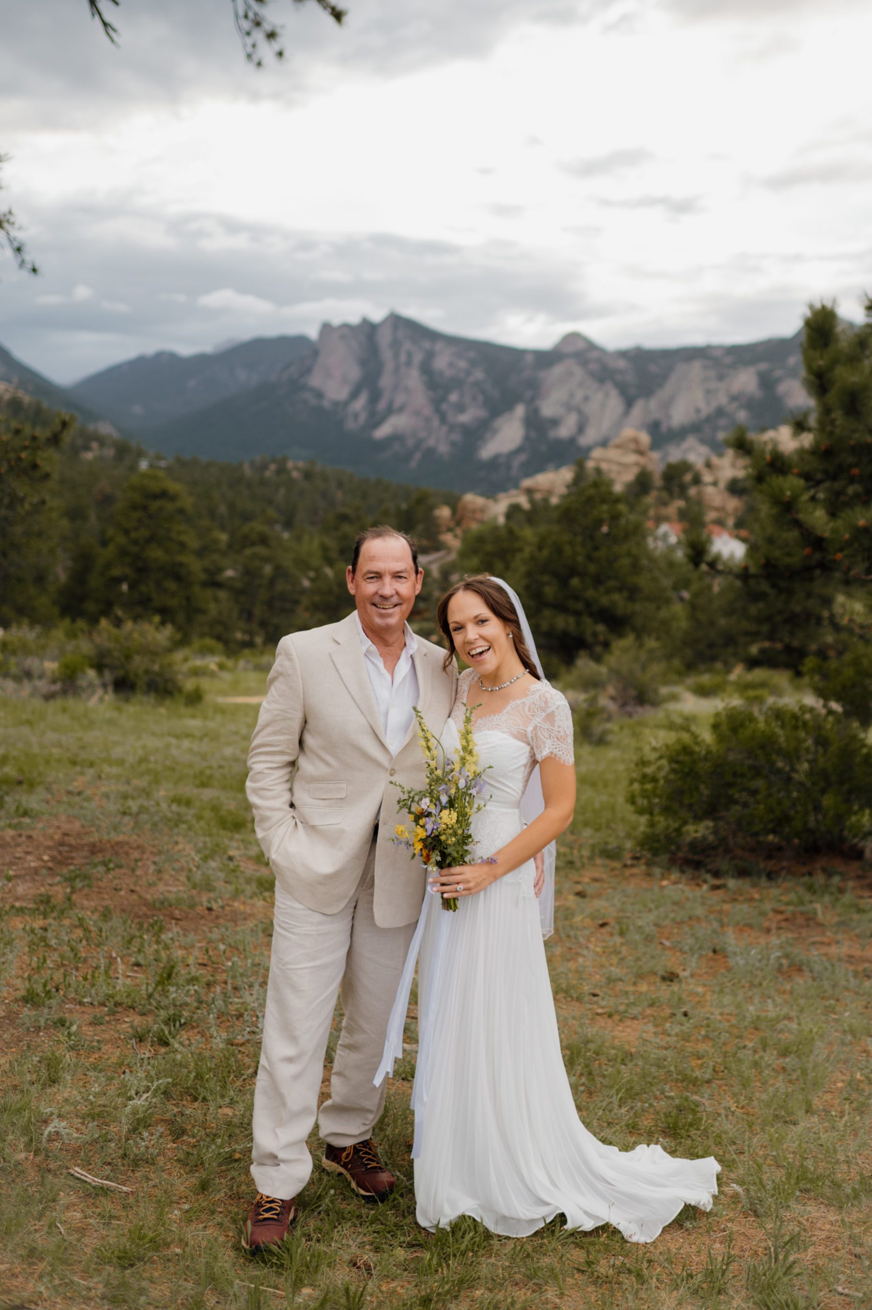 The bride and her father after her Knoll Willows elopement ceremony at Estes Park. 