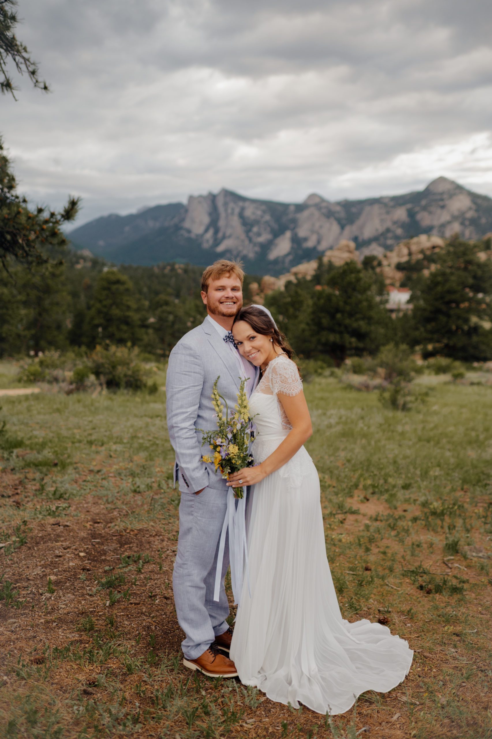 The bride and groom smile sweetly after their elopement at Knoll Willows in Estes Park.