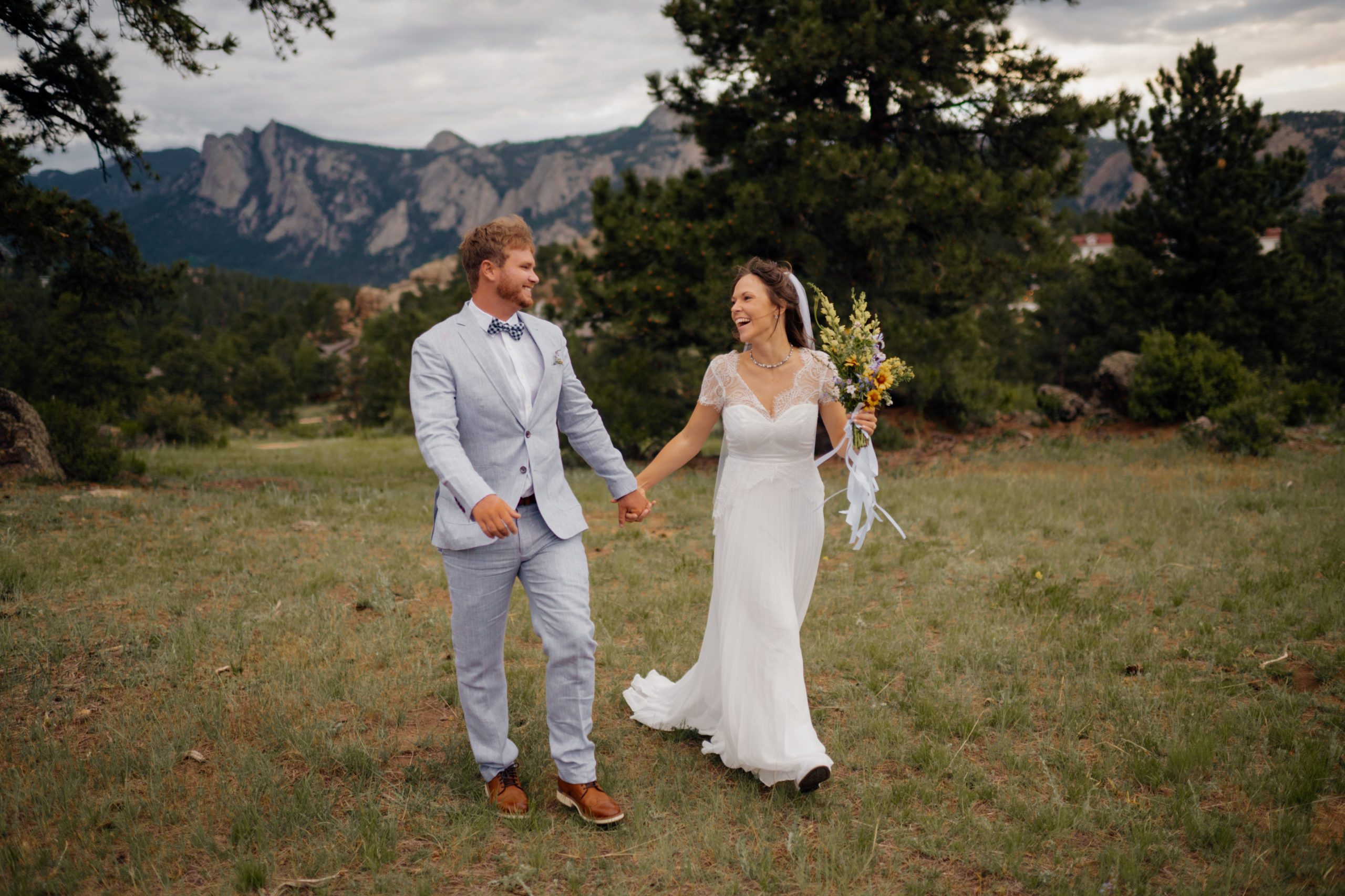 The bride and groom walking hand in hand in Knoll Willows on their elopement day in Estes Park. 