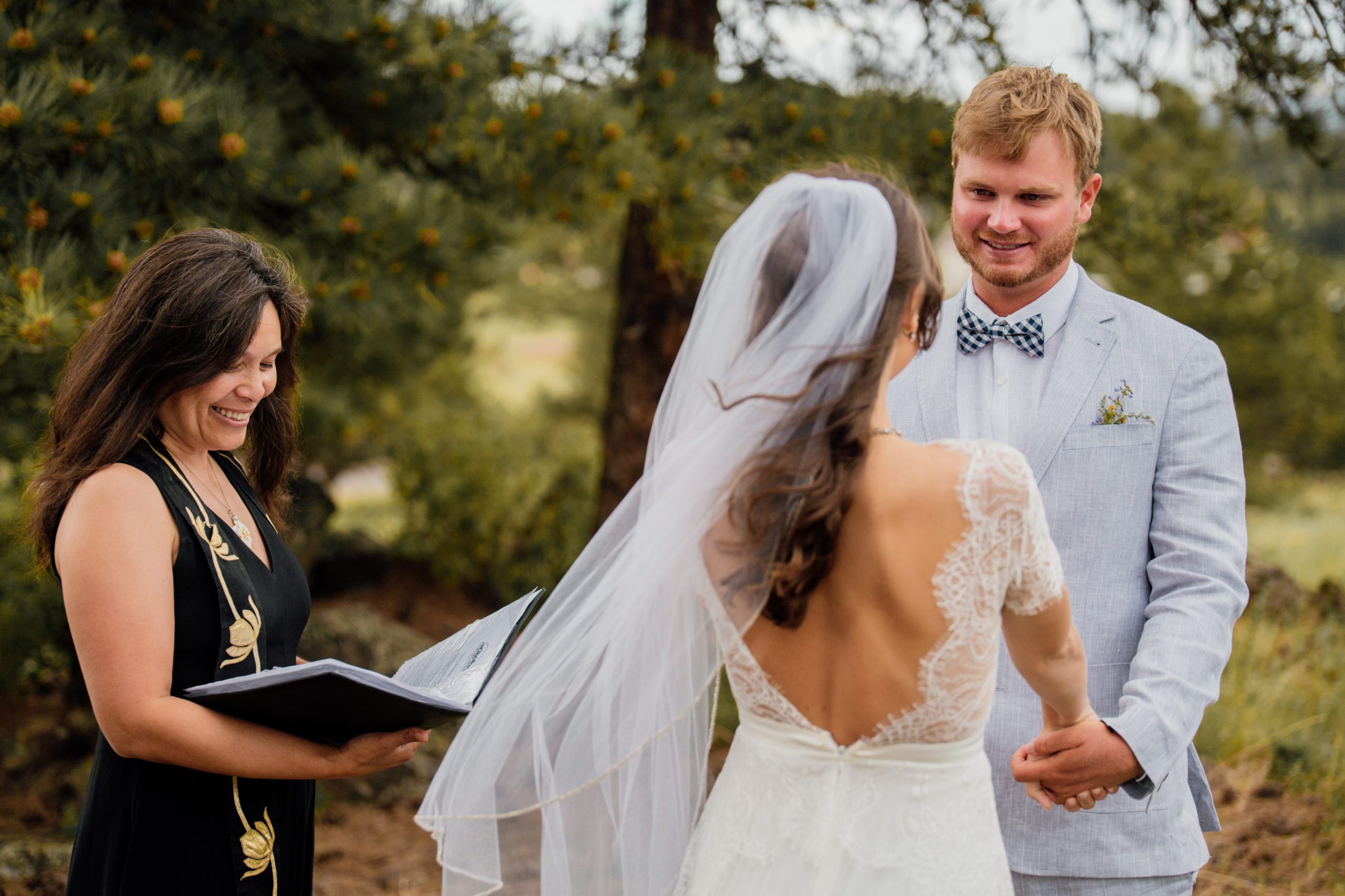 The bride and groom at the the alter at their Knoll Willows ceremony at Estes Park. 