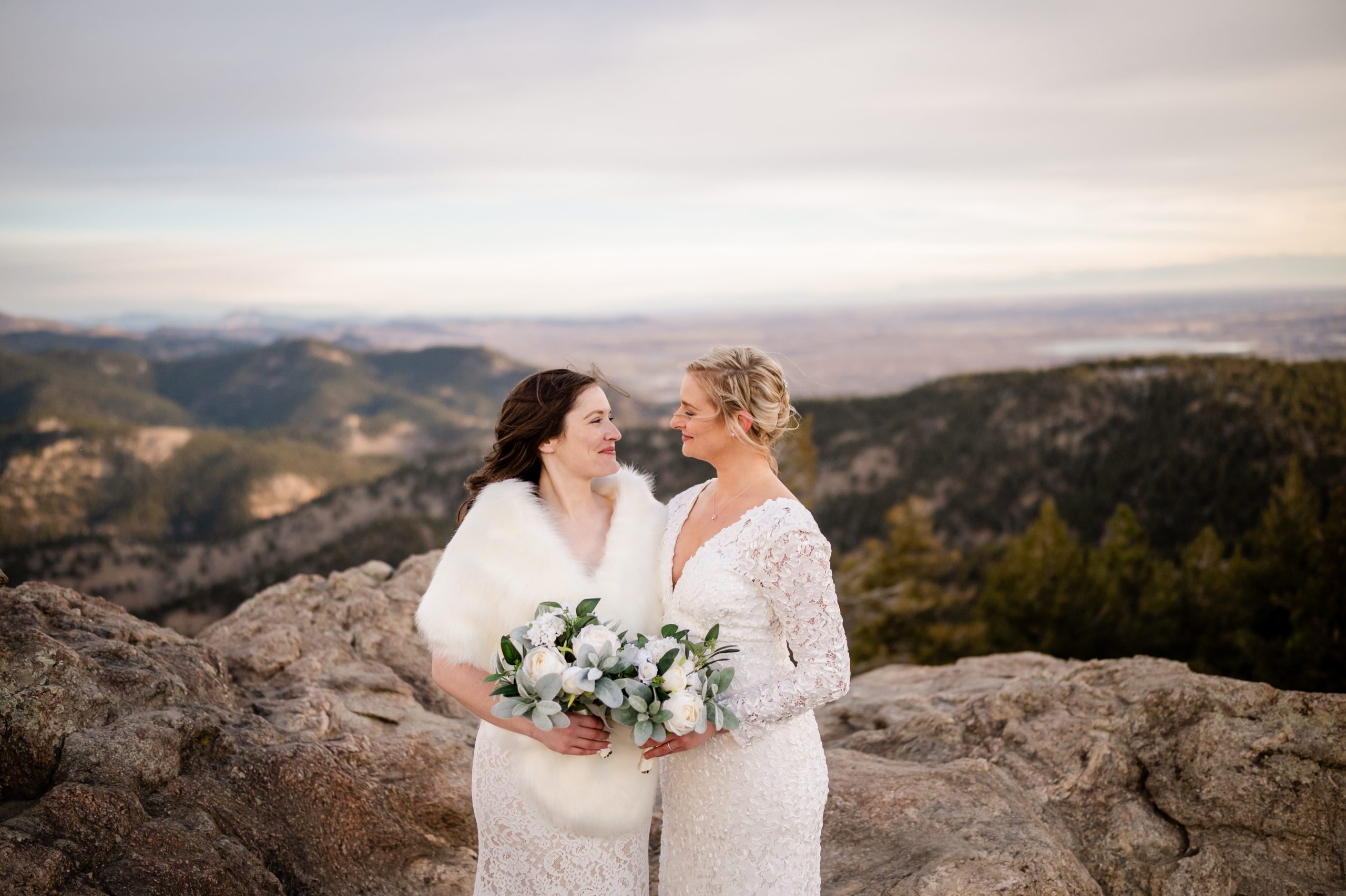 The brides looking at each other sweetly at their Lost Gulch elopement. 