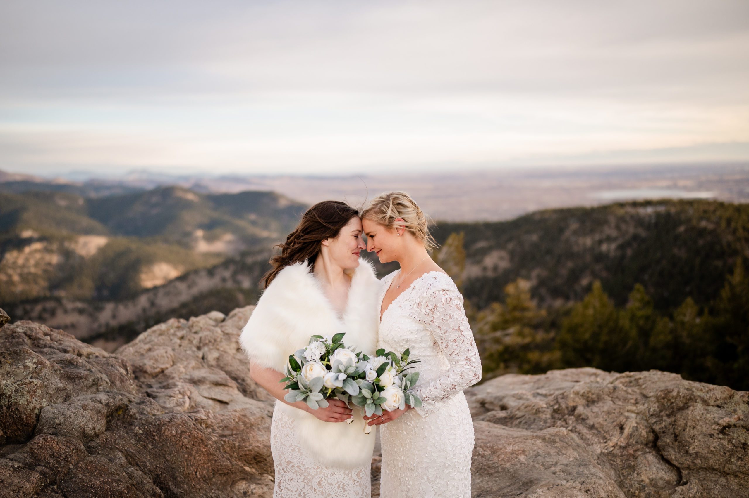 The bride's cuddle close, nose to nose at their Lost Gulch elopement. 