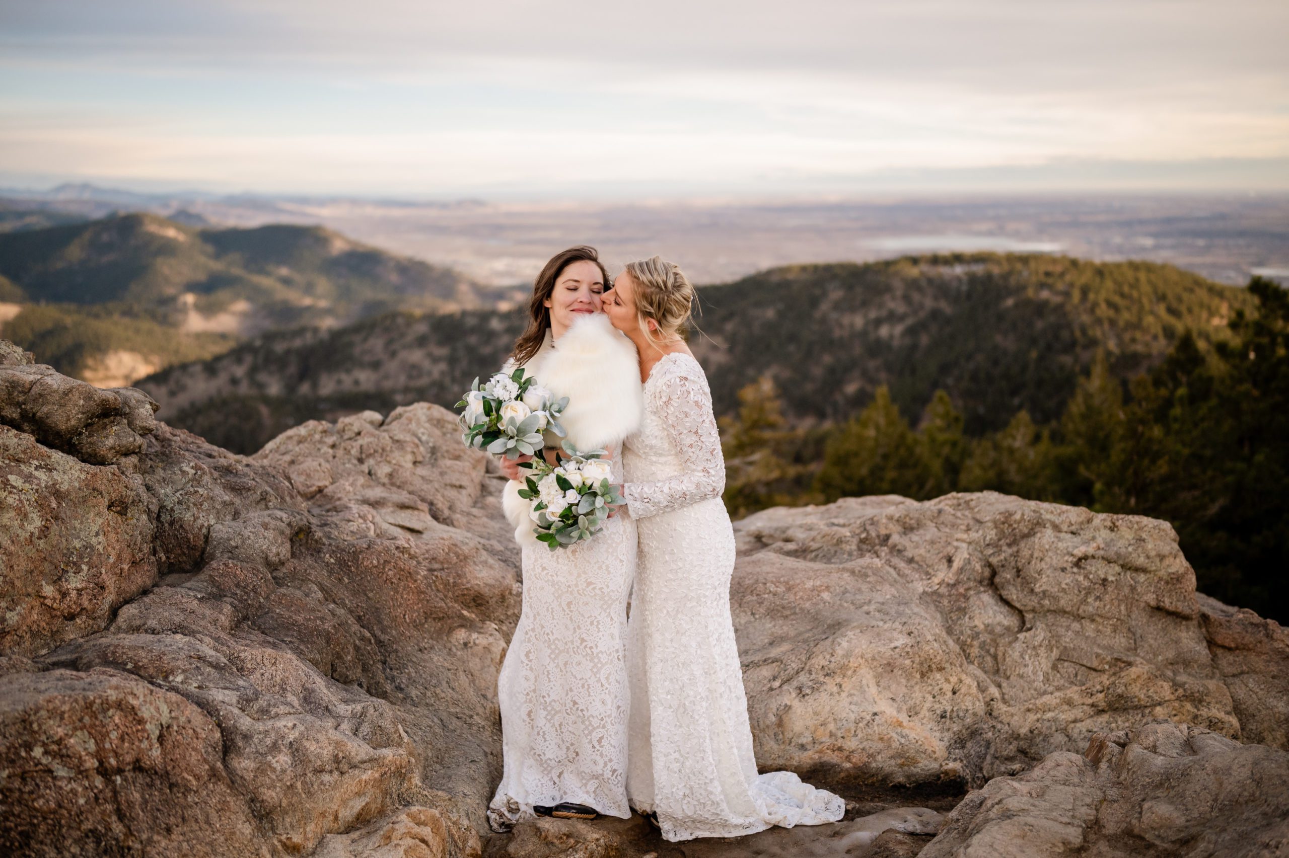 The bride kisses her wife on the cheek at their Lost Gulch elopement. 