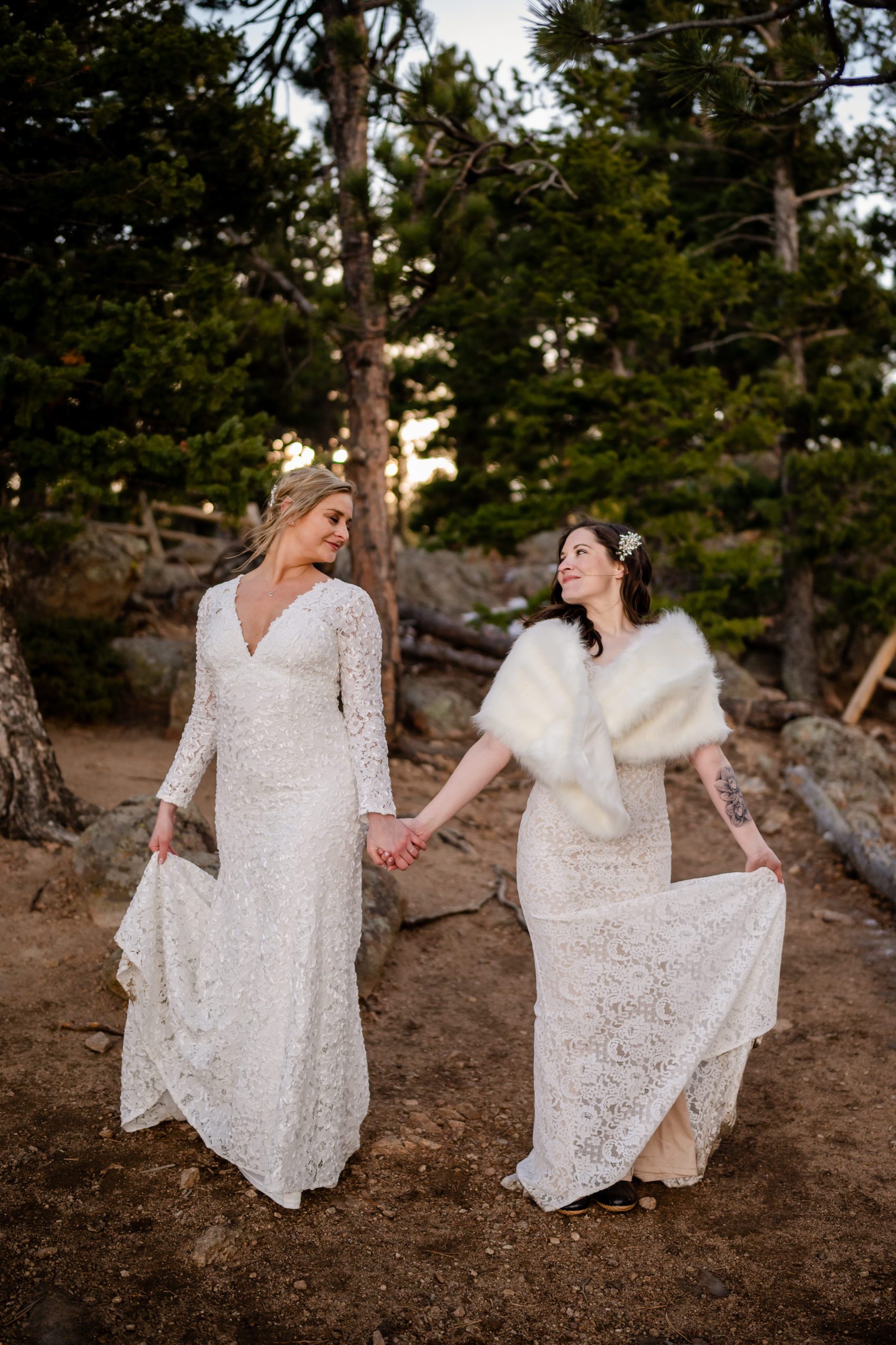 The bride's holding hands and looking at each other during their elopement at Lost Gulch. 
