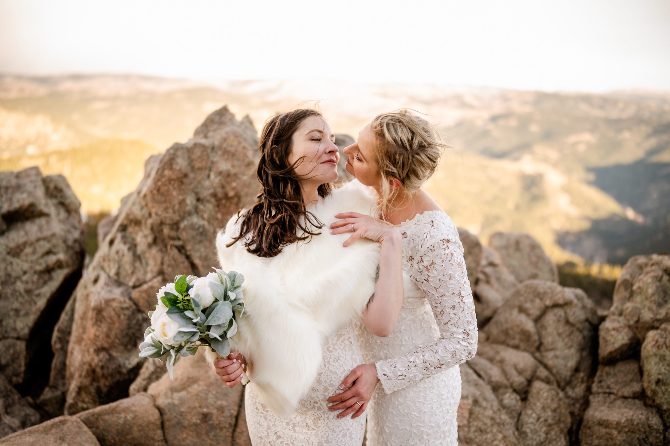 A beautiful shot of the brides looking at each other at top of the Lost Gulch at their elopement. 