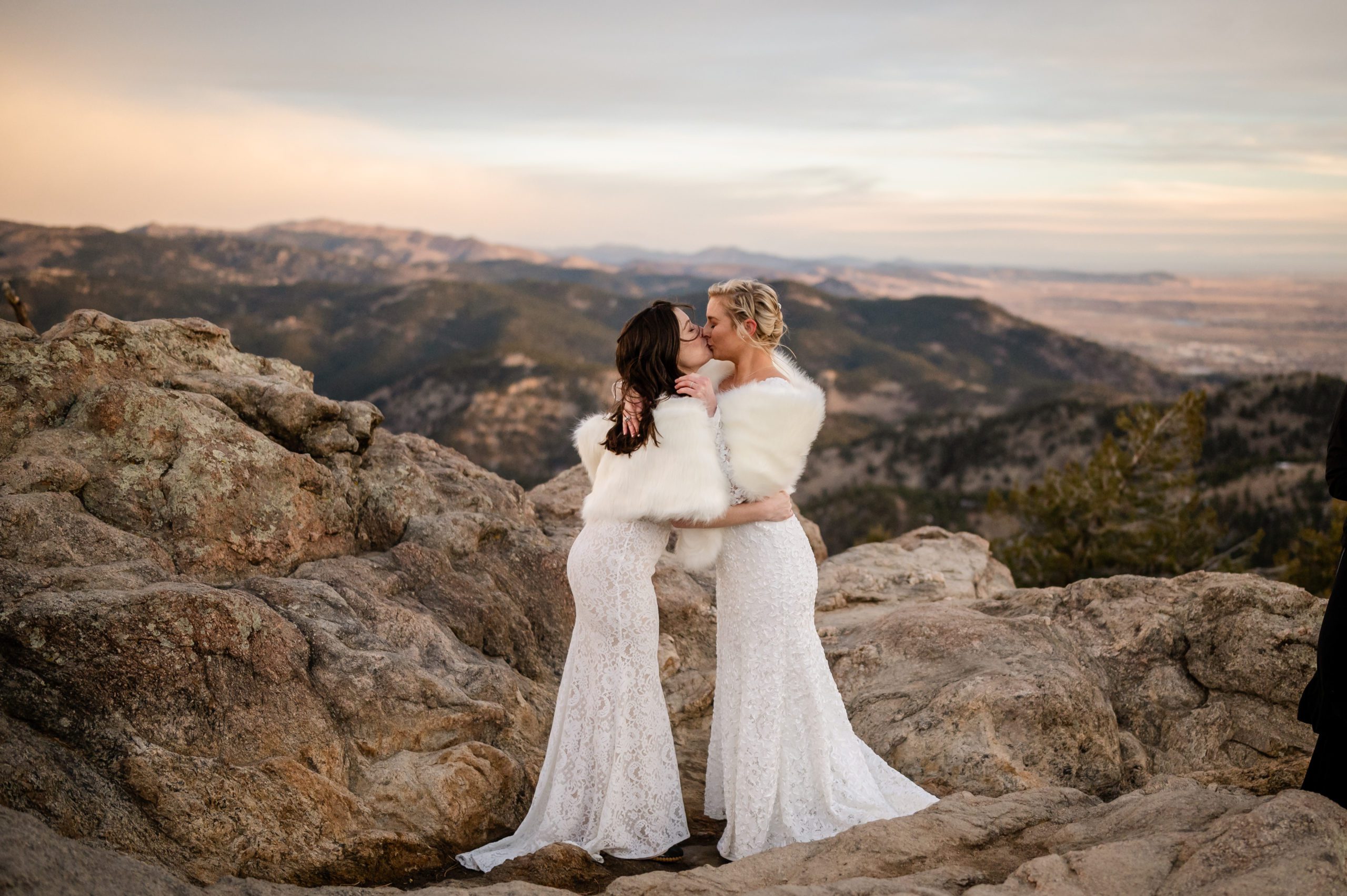 The two brides first kiss after their Lost Gulch elopement ceremony. 