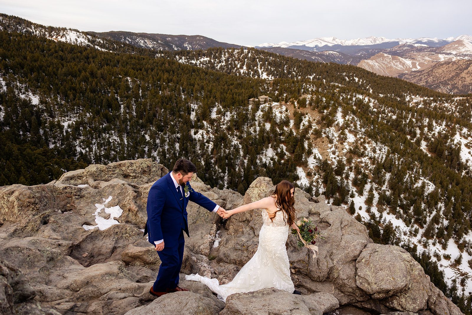 The bride leading her groom by the hand during their lost Lost Gulch elopement with  videography.