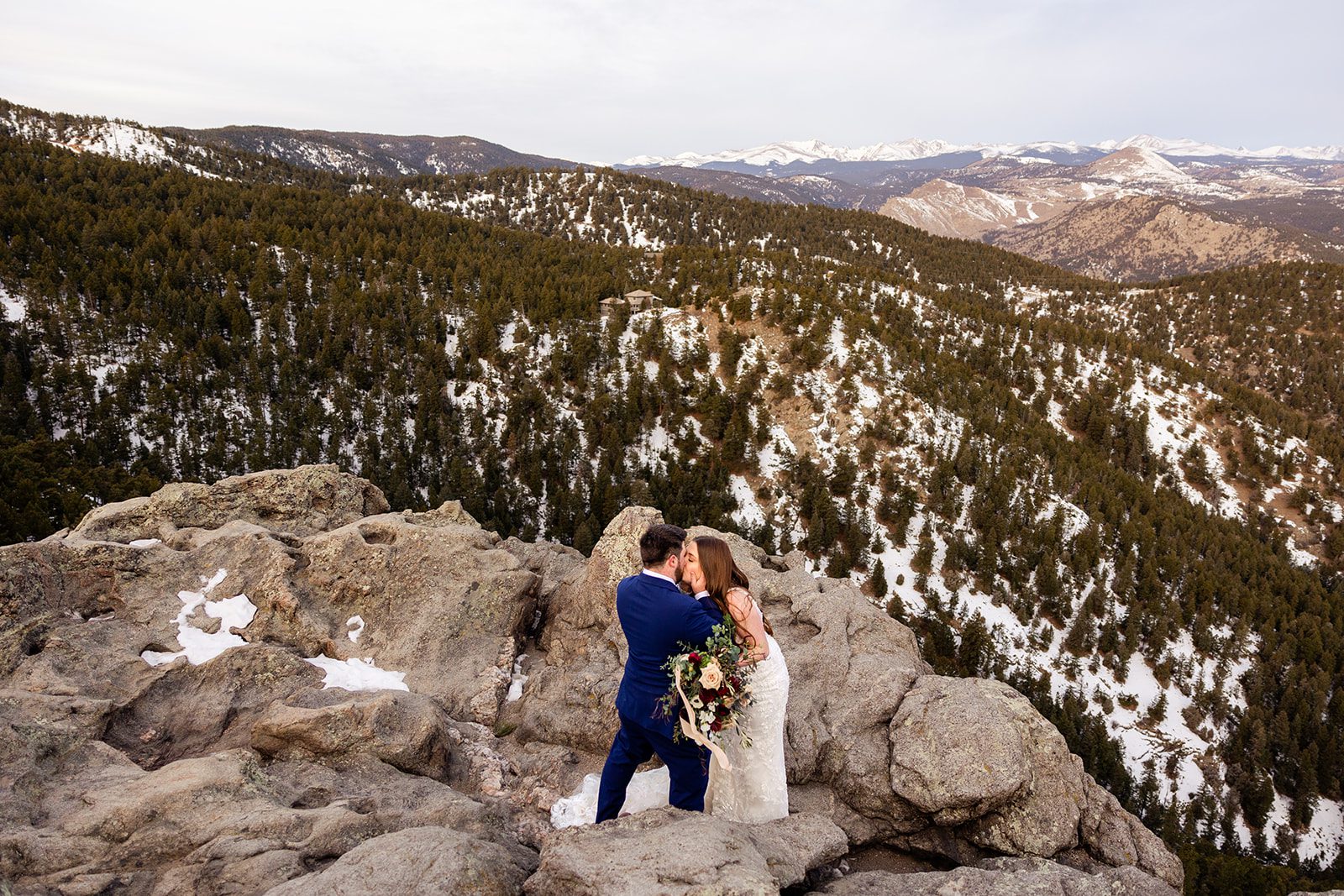 The bride and groom kissing on top of Lost Gulch during their elopement with videography. 