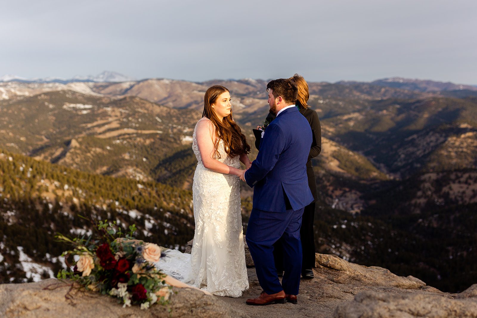 The bride listens to her groom during their  ceremony for their Lost Gulch elopement with  videography.
