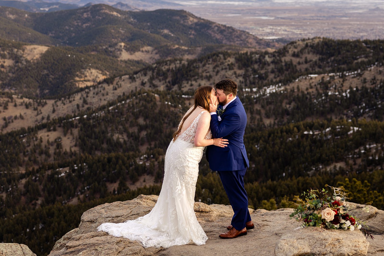 Groom and bride kiss during their Lost Gulch elopement with  videography.